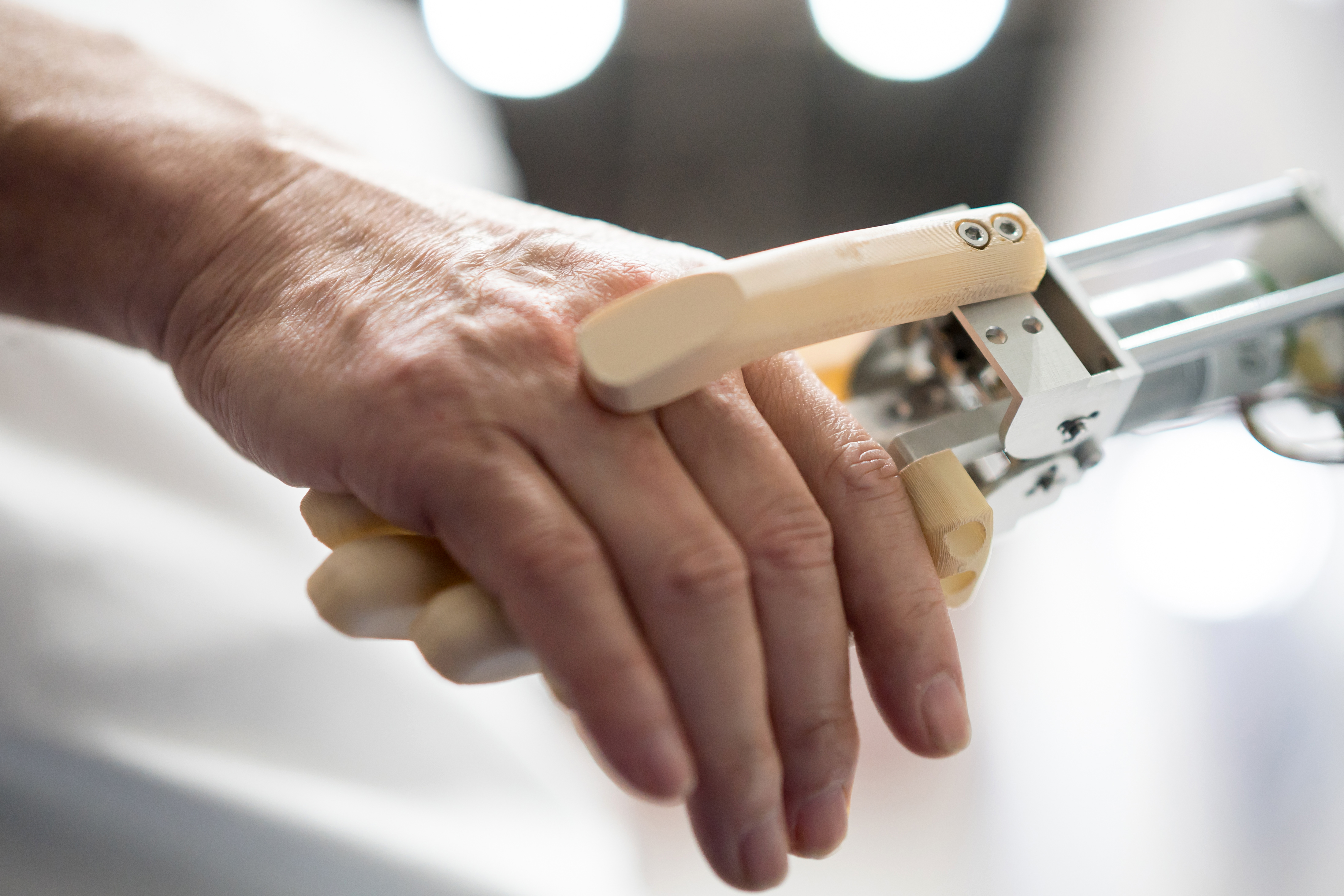 A person shakes hands with a robotic arm. (Photo: Tomohiro Ohsumi/Getty Images)