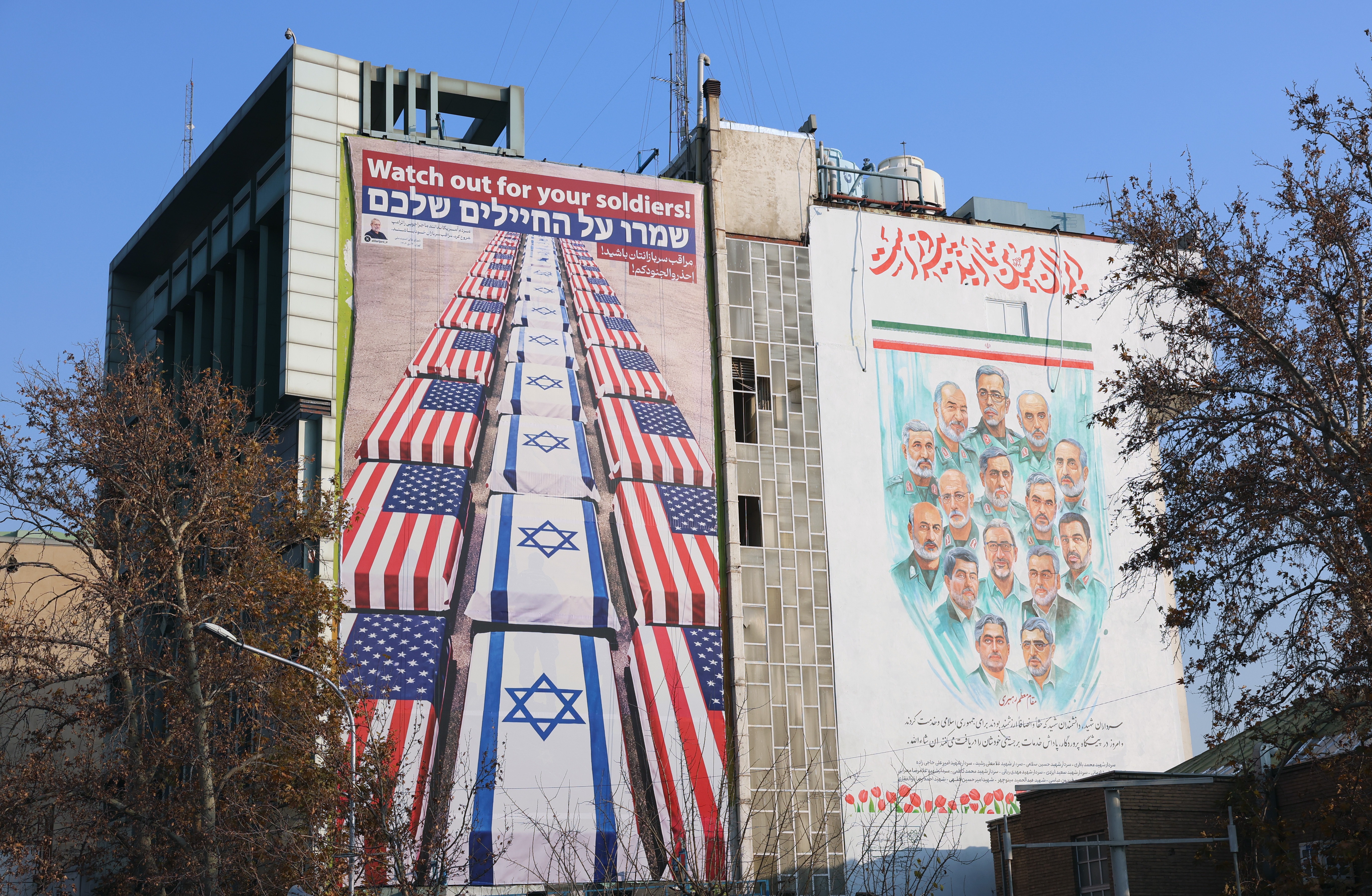 An anti-US and Israeli billboard carrying a message from the Secretary of the Supreme National Security Council, Ali Larijani, reading 'Watch out for your soldiers,' following a social media message by US President Donald Trump supporting anti-government protests, displayed at Palestine Square in Tehran, Iran, 04 January 2026. Following Trump's message, the Iranian Foreign Ministry issued a statement condemning his remarks as interference in Iran's internal affairs. The ministry warned that Tehran's 'response to any aggression will be swift, decisive, and comprehensive,' adding that the United States bears full responsibility for regional instability.  EPA/ABEDIN TAHERKENAREH