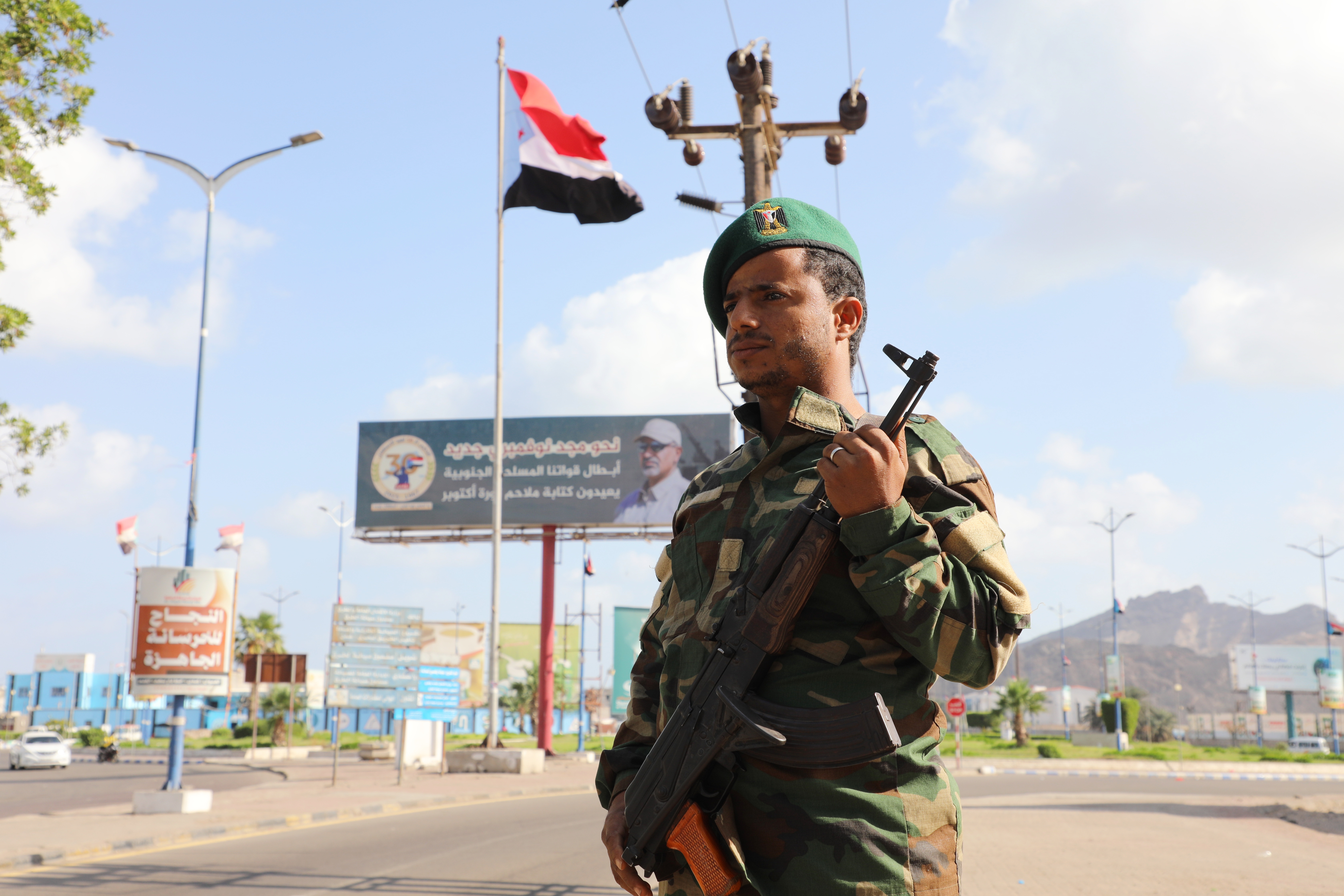 A South Yemeni flag flutters as a member of the UAE-backed Southern Transitional Council (STC) troops mans a checkpoint amid high tensions the Saudi-backed Yemeni forces, in the southern port city of Aden, Yemen, 05 January 2026. The Saudi-backed Yemeni government forces have announced that they have retaken full control of the eastern Yemeni provinces of Hadramout and Al-Mahra after expelling the UAE-backed Southern Transitional Council (STC) forces.The STC controls much of southern Yemen, including the port city of Aden, the seat of the internationally recognized government, with which it is currently at loggerheads.  EPA/NAJEEB MOHAMED