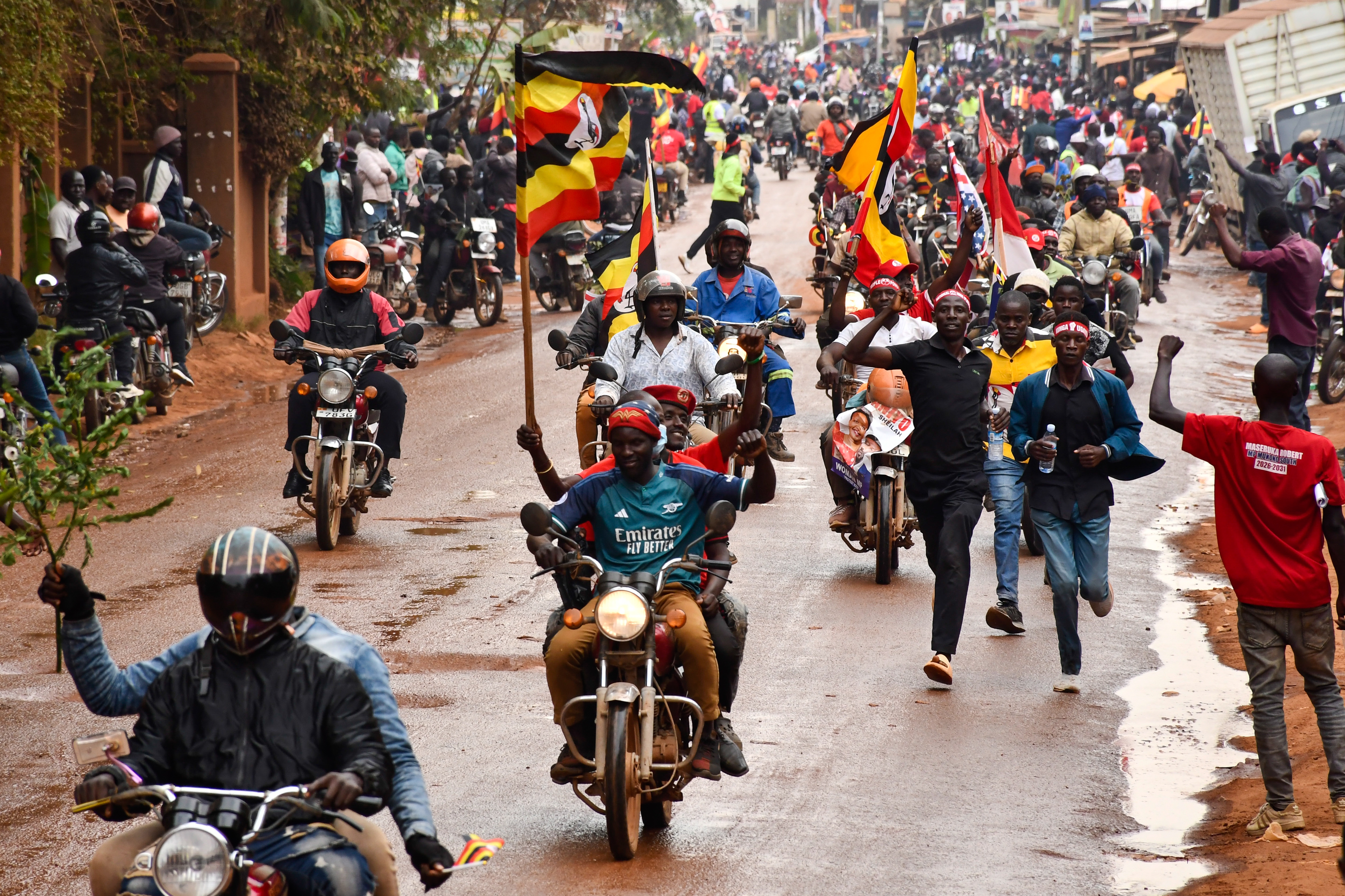 Supporters wave flags during a campaign meeting by opposition National Unity Platform (NUP) leader Robert Kyagulanyi, known as Bobi Wine, near the Saint Joseph Primary School playing grounds in Nantabulirwa village, Mukono District, Uganda, 09 January 2026. Eight presidential candidates, including incumbent Yoweri Museveni and NUP candidate Bobi Wine, are contending in the presidential election scheduled for 15 January.  EPA/ISAAC KASAMANI