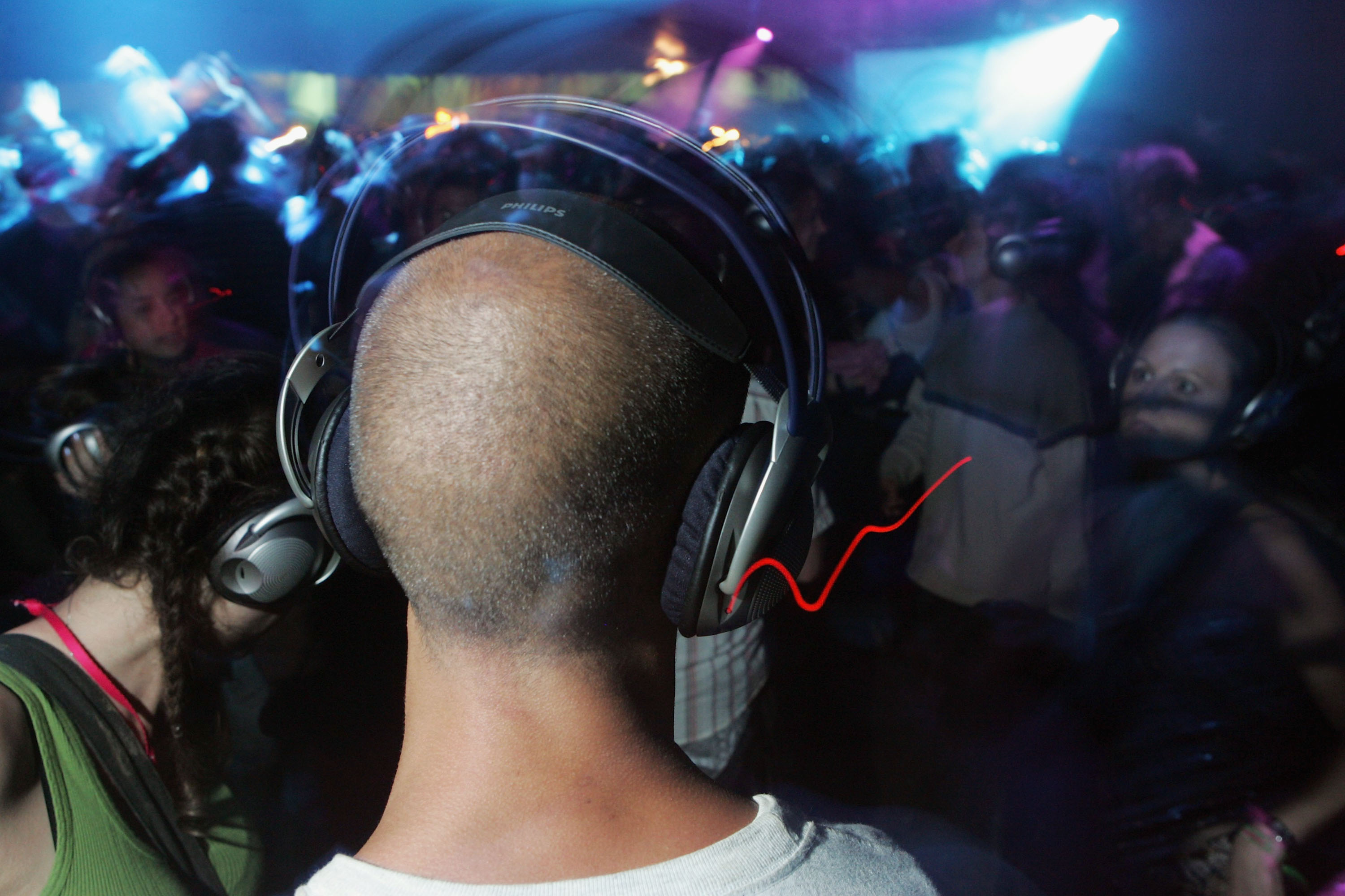 A reveller enjoys the silent all-night disco in the Dance Tent on the second day of the Glastonbury Music Festival 2005 at Worthy Farm, Pilton on June 25, 2005 in Somerset, England. (Photo by Matt Cardy/Getty Images)
