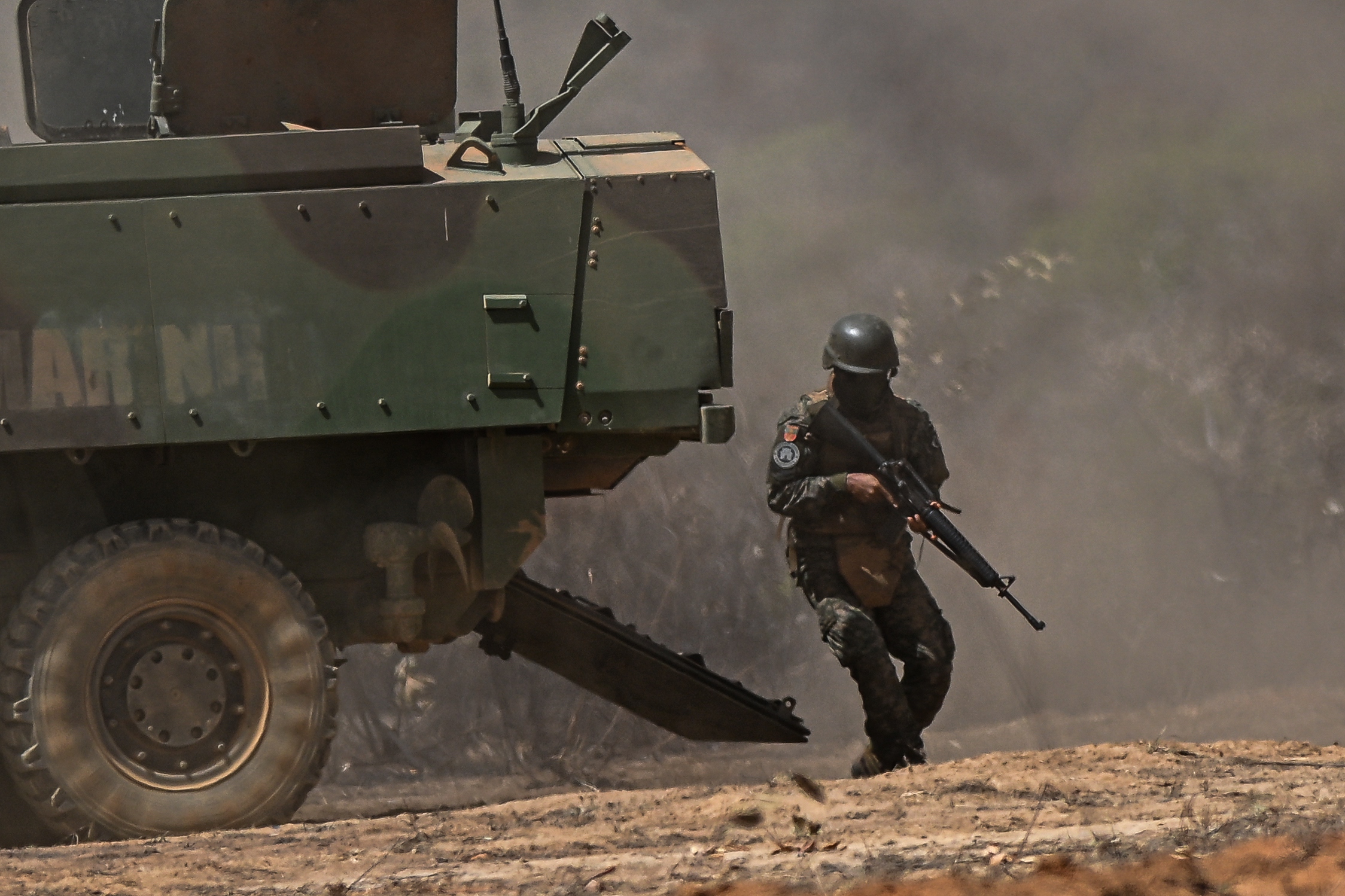 A soldier participates in 'Operativo Formosa,' the largest military exercise in the Central Plateau conducted by the Brazilian Navy, at the Formosa Instruction Center (CIF) in Formosa, Goi?s State, Brazil, 11 September 2024. During the exercise, coordinated attacks are simulated using aircraft, helicopters, armored vehicles, artillery, and ground troops, making it a comprehensive training for the Brazilian military.  EPA/Andr? Borges