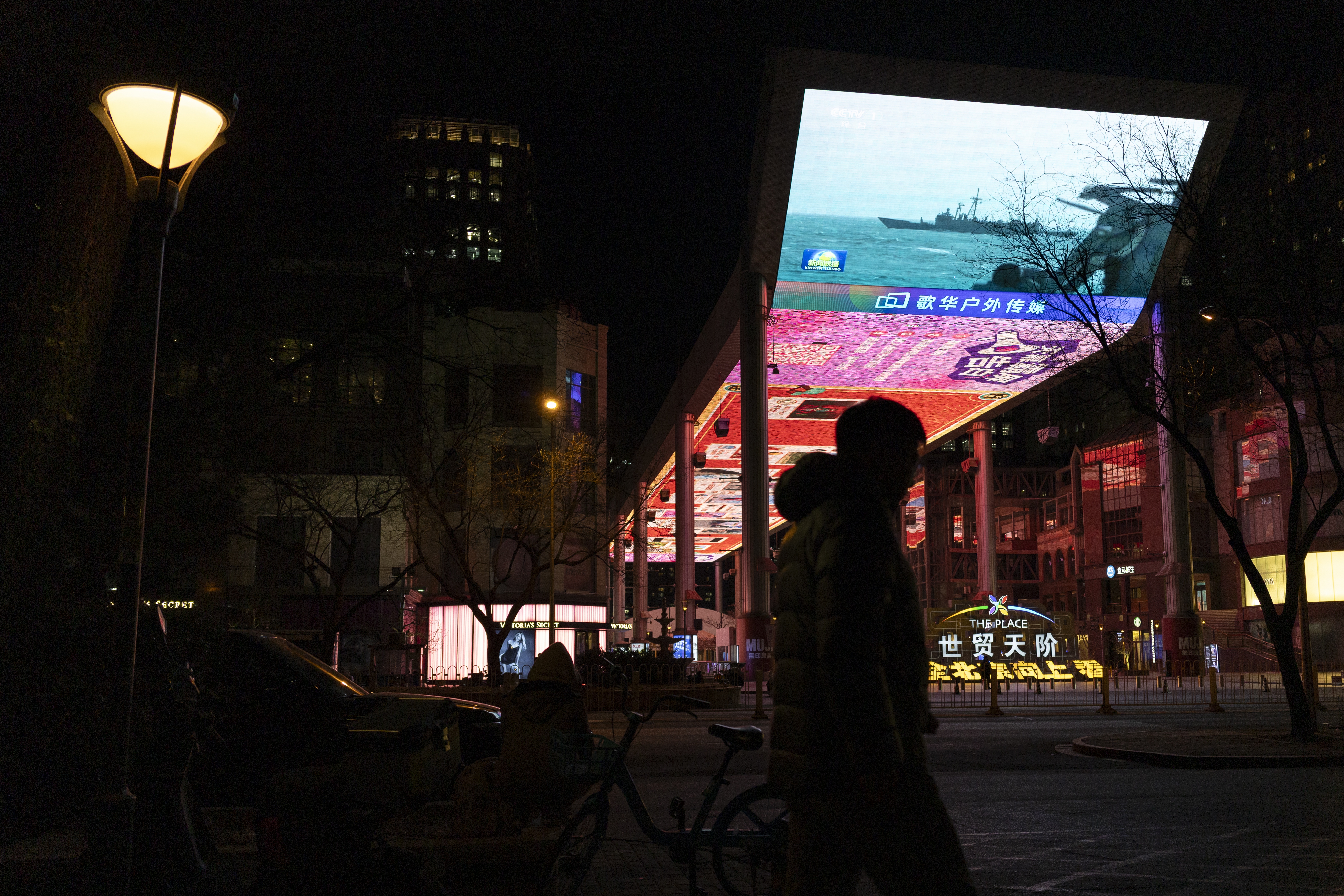 A man walks past a screen broadcasting news about military drills conducted by China around Taiwan, in Beijing, China, 30 December 2025. China conducted military drills by the People's Liberation Army (PLA) around Taiwan on 29 and 30 December.  EPA/ANDRES MARTINEZ CASARES