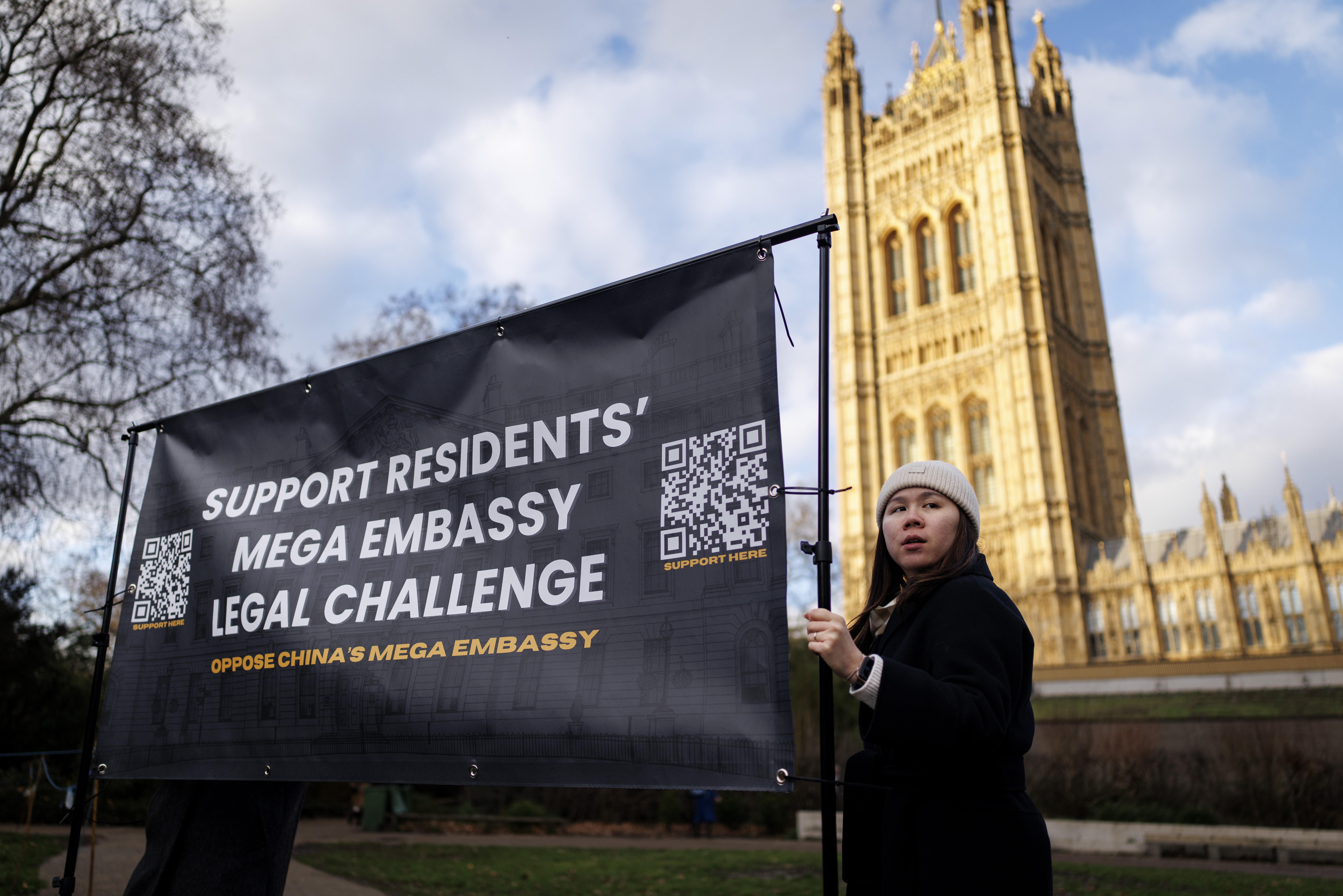 People hold a banner to protest against the UK government's approval of the new Chinese Embassy to the UK, at Victoria Tower Gardens, in London, Britain, 20 January 2026. The British Housing Secretary has approved planning permission and listed building consent for a new Chinese 'super-embassy' at Royal Mint Court in London despite controversy over security concerns.  EPA/TOLGA AKMEN