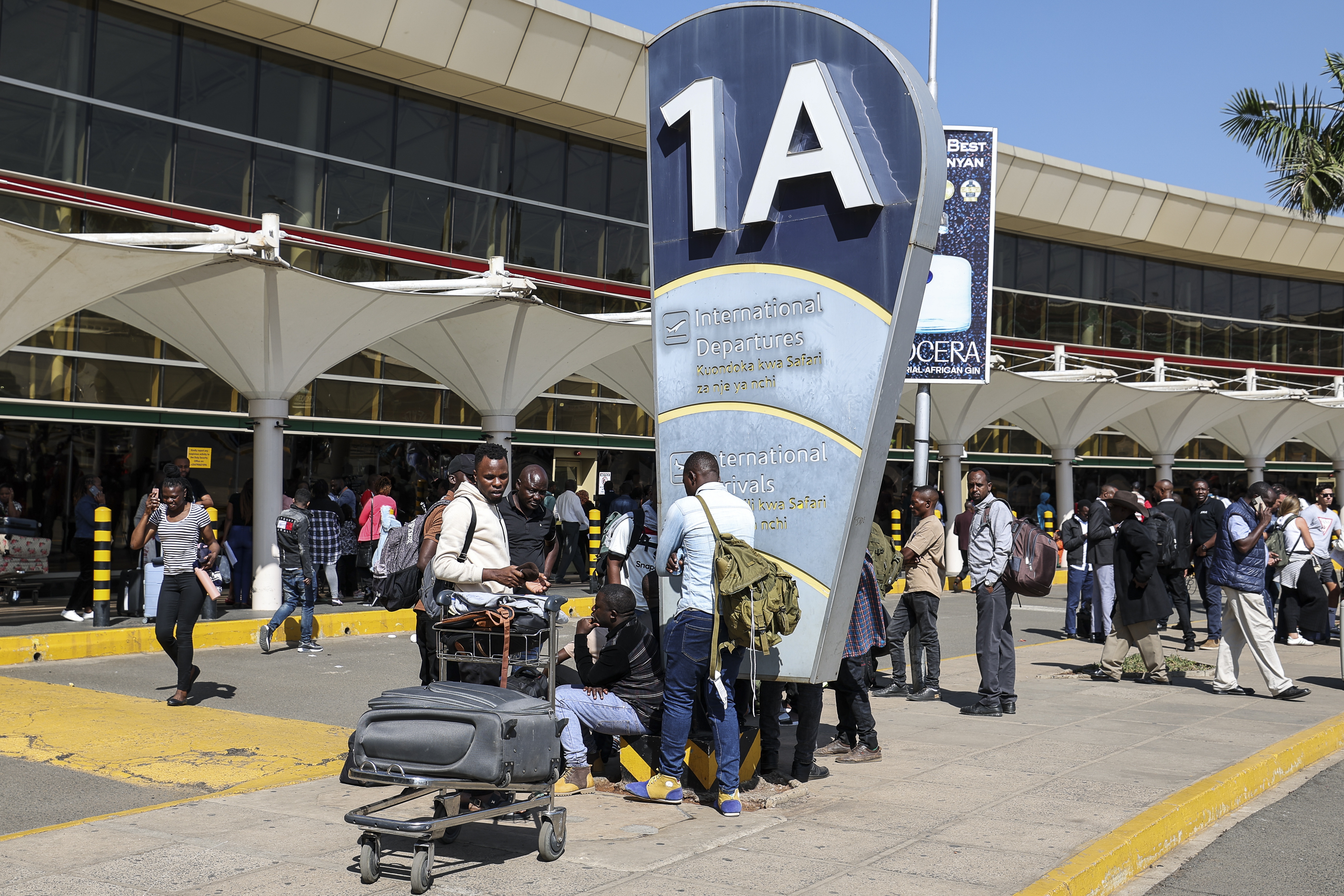 Stranded passengers wait outside the Jomo Kenyatta International Airport (JKIA) after operations were paralyzed by a Kenyan Aviation workers' strike in Nairobi, Kenya, 11 September 2024. Several International and local flights were disrupted, and thousands of passengers left stranded, after the Kenya Airport Workers Union went on strike over a planned 30-year lease of the Jomo Kenyatta International Airport (JKIA) to Indian based company Adani Airport Holdings Ltd.  EPA/DANIEL IRUNGU
