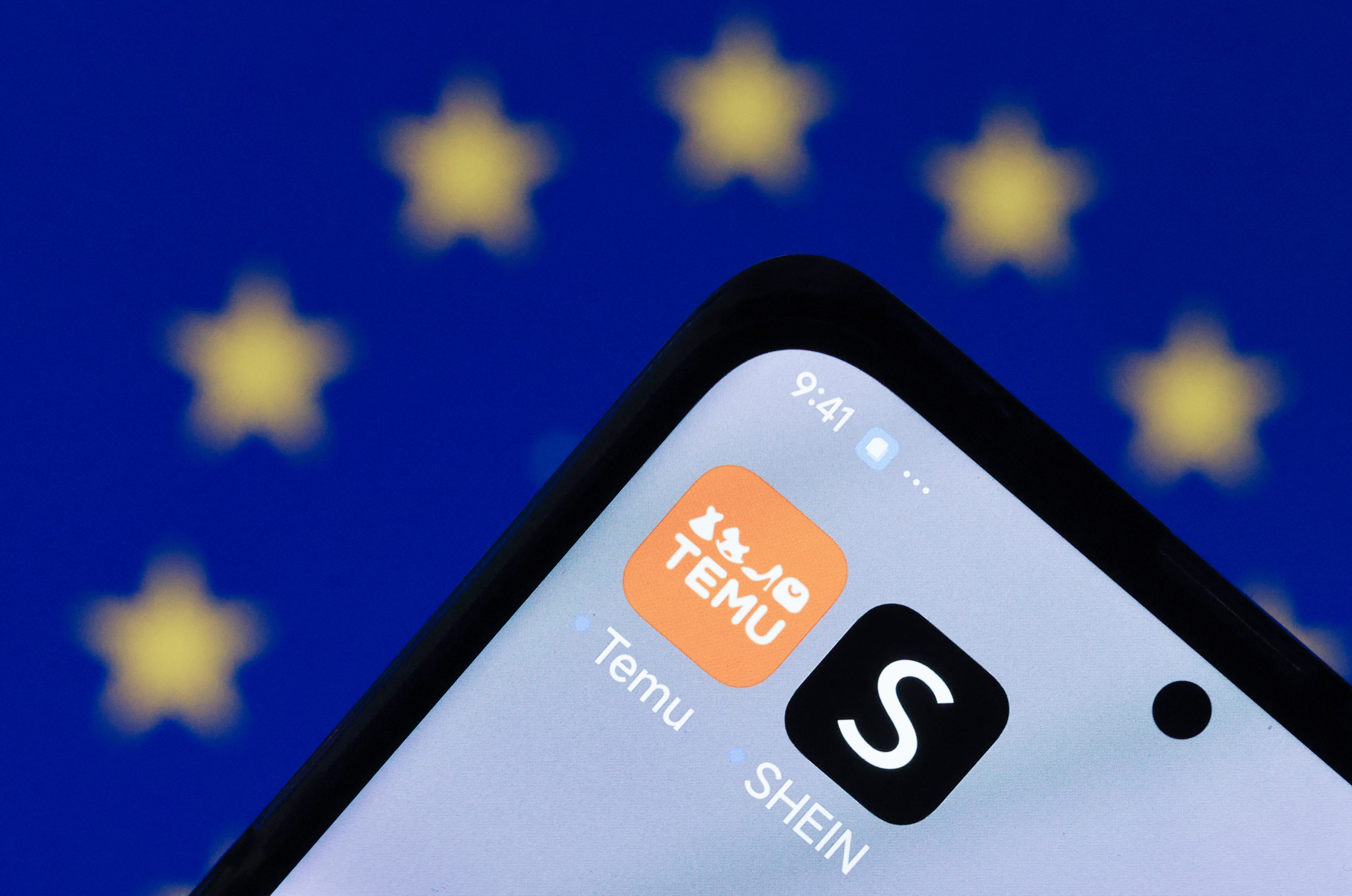 The Temu (L) and Shein e-commerce apps are displayed on a smartphone against a screen with the European Union (EU) flag (rear), in Berlin, Germany, 07 February 2025. As part of its e-commerce customs and trade proposal, the European Commission proposed on 05 February, measures to tackle risks from cheap imports sold online by non-EU retailers and marketplaces, including enhanced customs controls.  EPA/HANNIBAL HANSCHKE