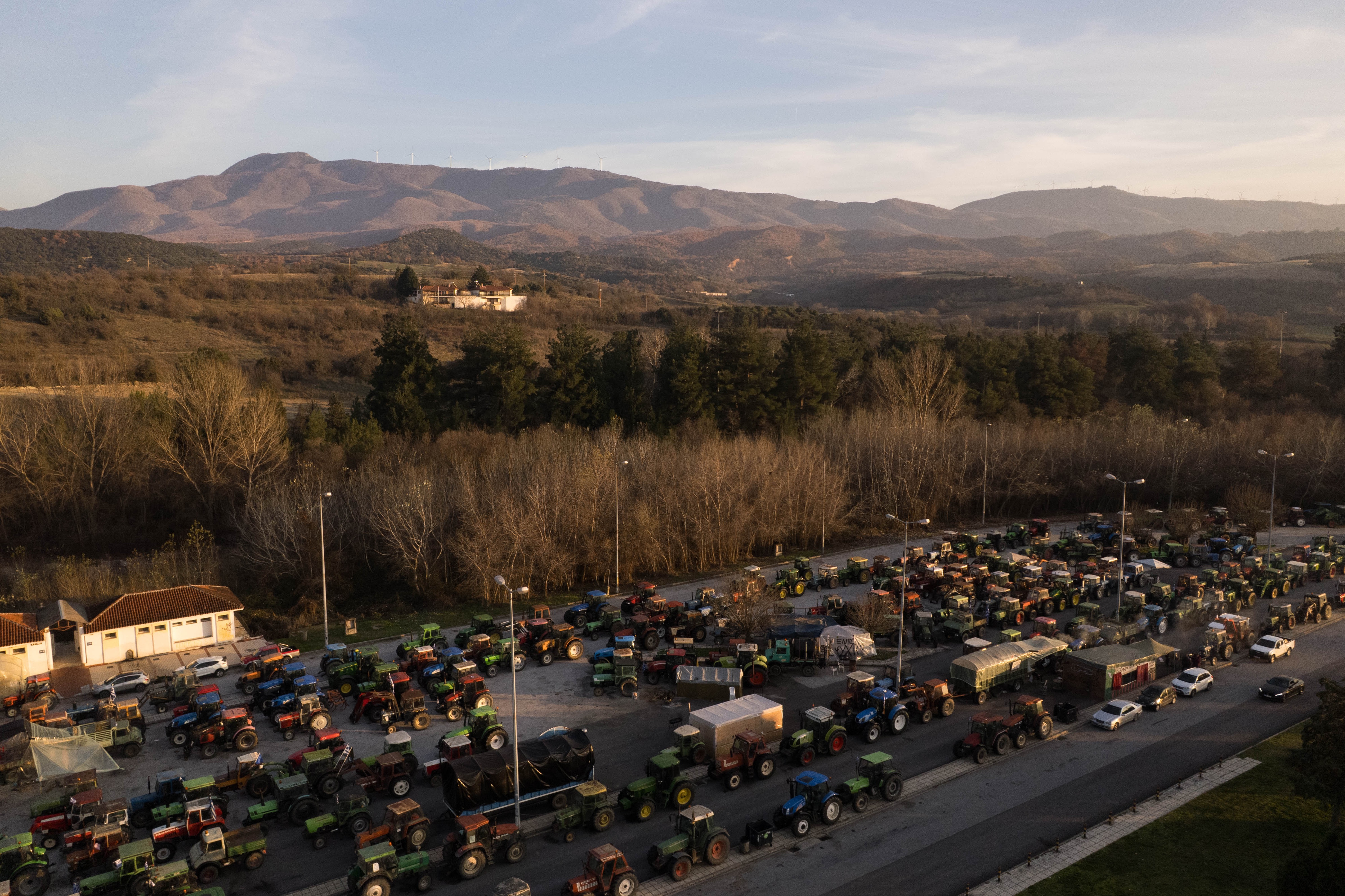 Tractors and agricultural vehicles line up at the farmers' blockade at the Promachonas customs office on the border with Bulgaria, in Serres, Greece, 19 December 2025. The farmers and livestock breeders proceeded with a ten-hour blockade for trucks of all types starting at 12:00 PM over rising costs and delayed subsidies.  EPA/ACHILLEAS CHIRAS