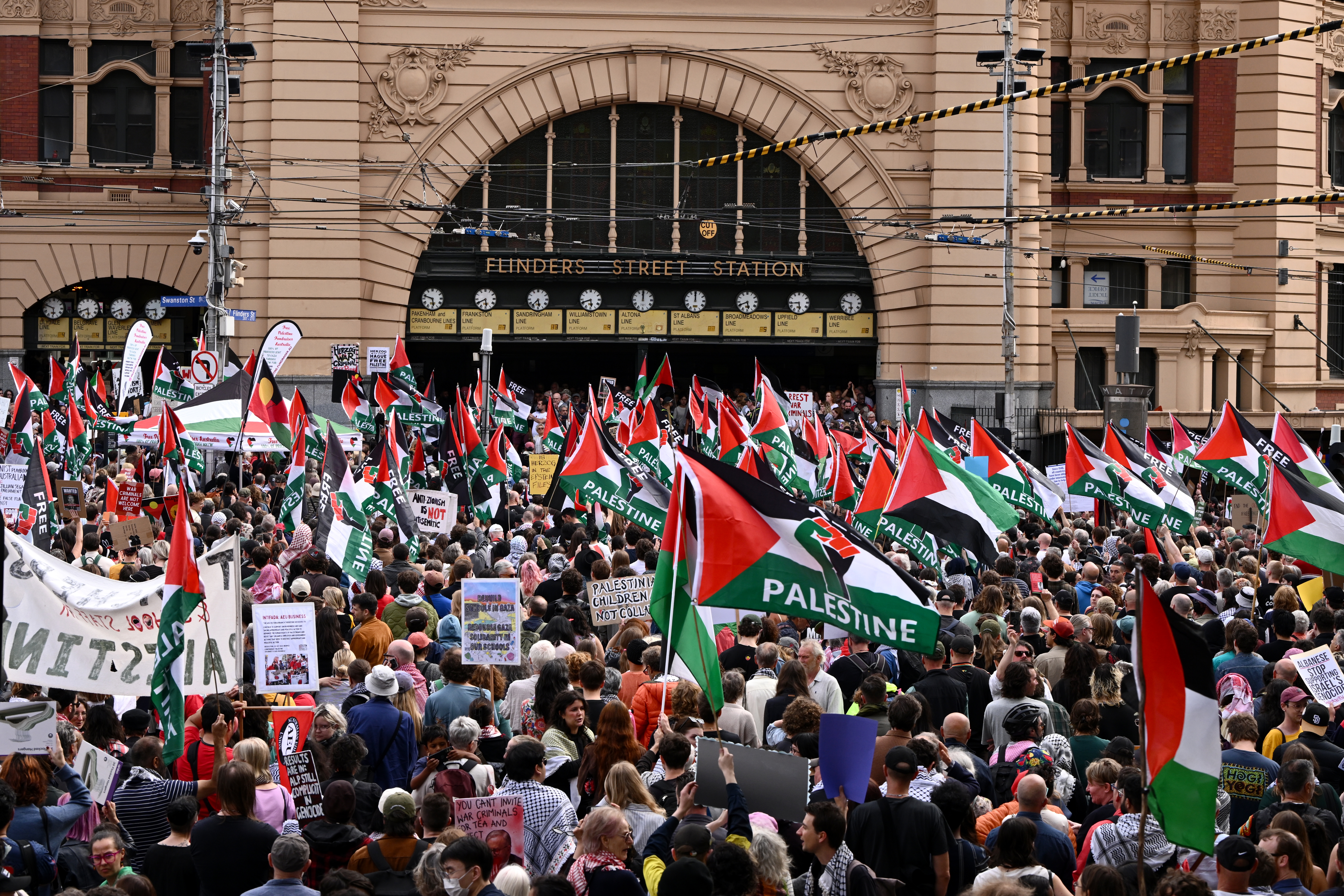 Protesters gather outside Flinders Street Station in Melbourne, Victoria, Australia, 09 February 2026, to demonstrate against the state visit of Israeli President Isaac Herzog. Herzog is on a four-day visit to Australia to meet with government officials and Jewish community leaders.  EPA/JOEL CARRETT  AUSTRALIA AND NEW ZEALAND OUT
