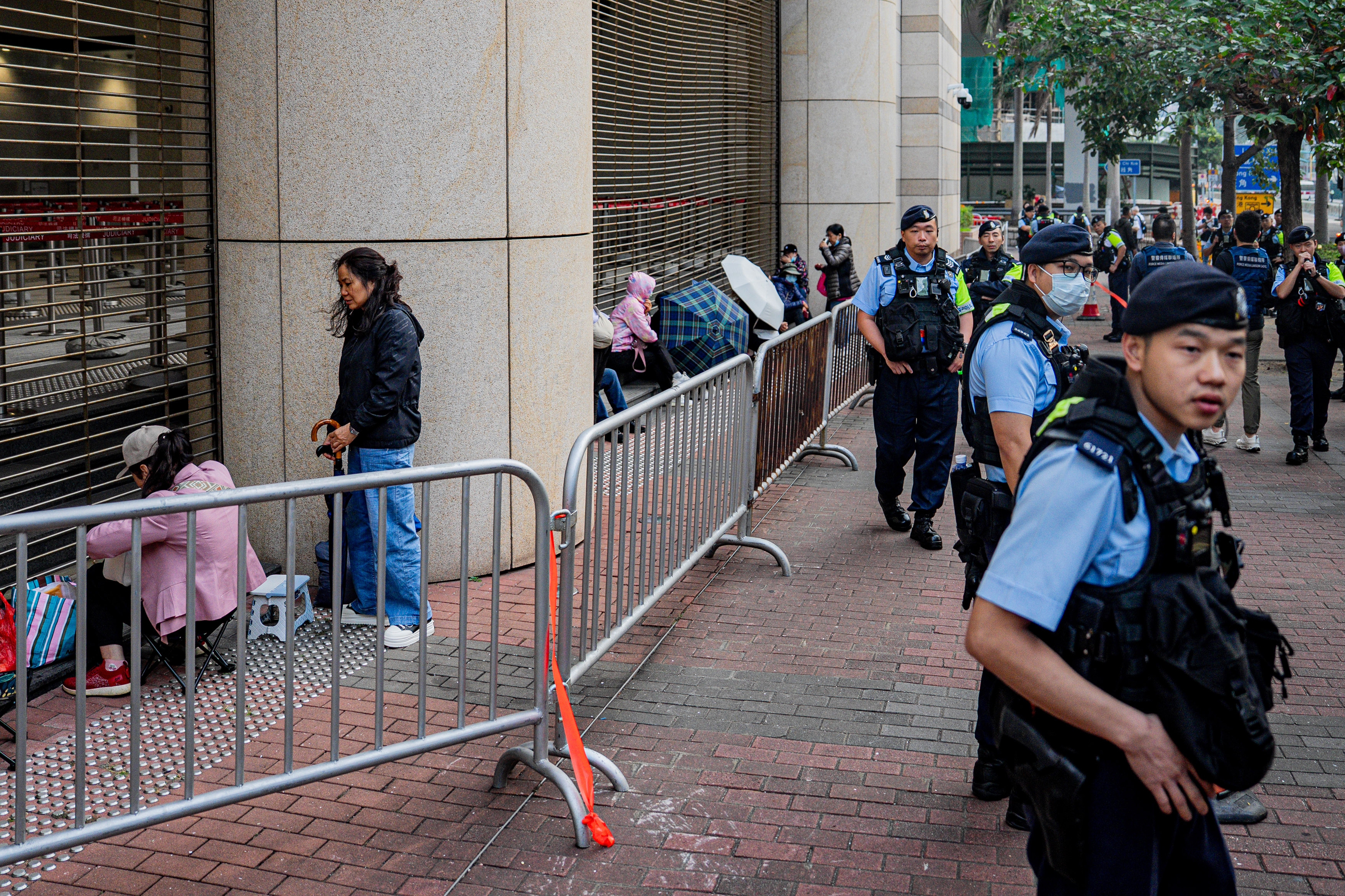Police officers stand guard outside of the West Kowloon Magistrates' Court in Hong Kong, China, 23 February 2026. The court rules today on the appeals of 12 activists and politicians convicted under the national security law for participating in a 2020 primary election.  EPA/LEUNG MAN HEI