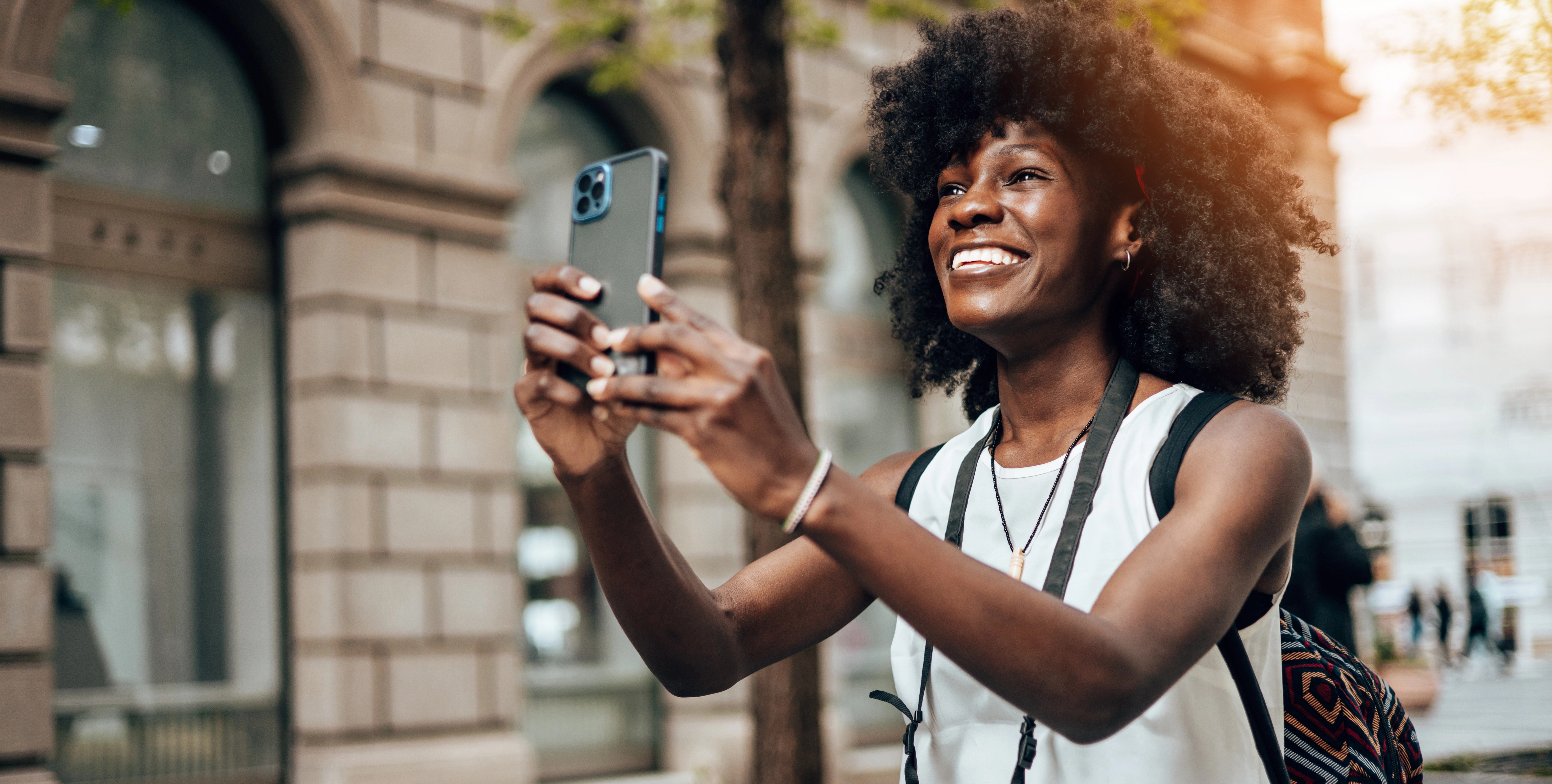 A happy woman taking a selfie.
