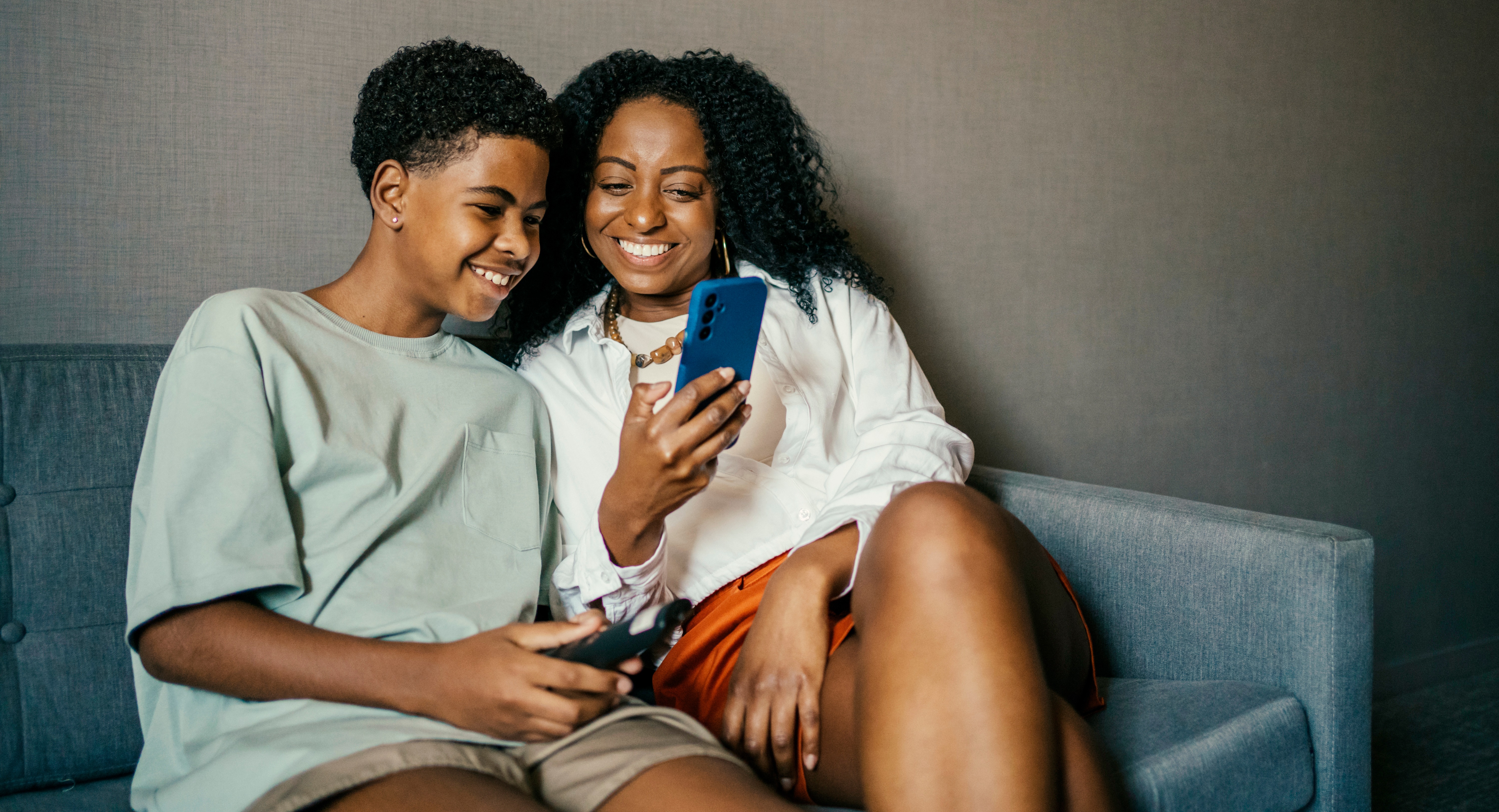 Mother and son using smart phone.