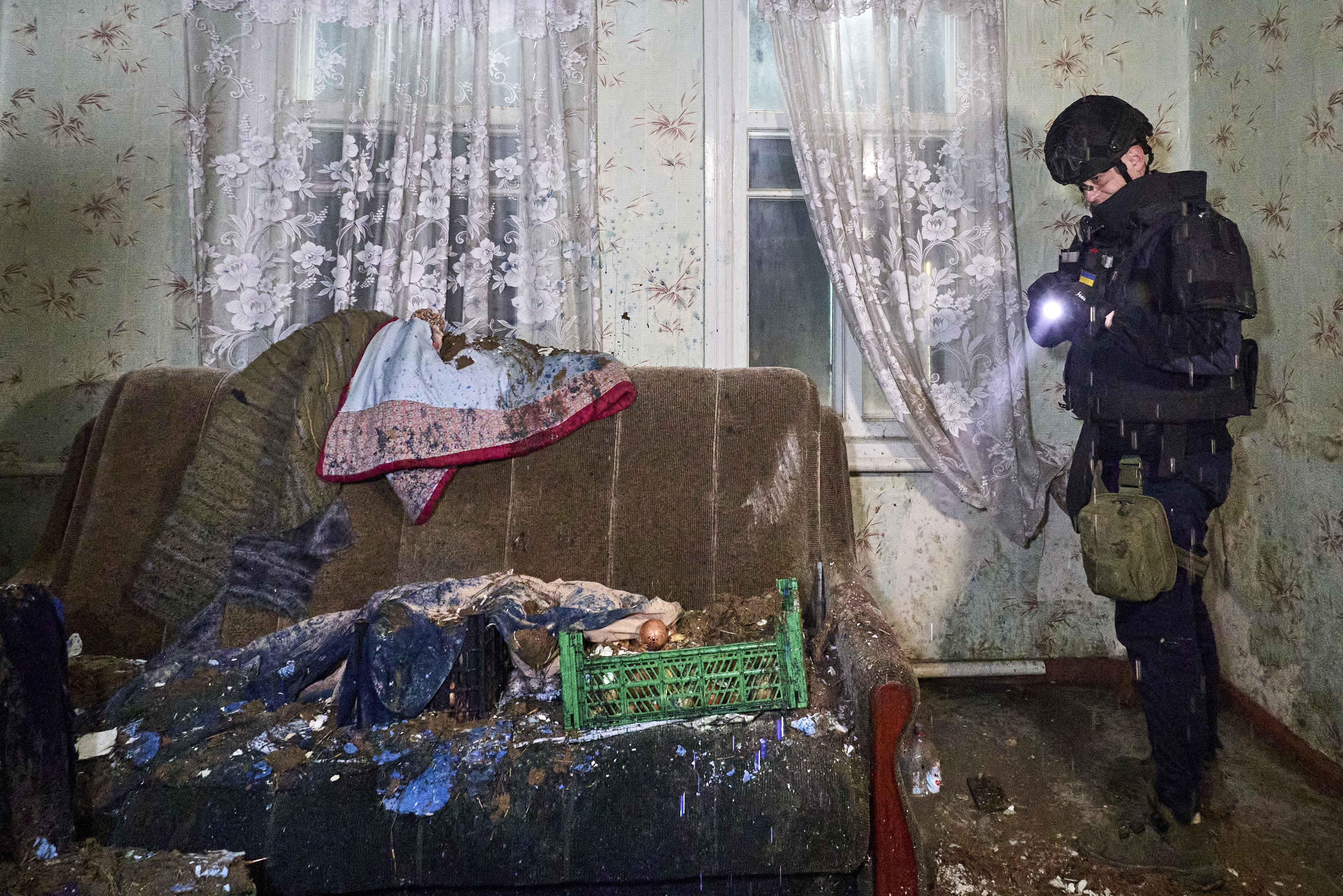 A Ukrainian policeman inspects a damaged room at the site of a Russian drone strike on a private building in Kharkiv, northeastern Ukraine, 25 March 2026, amid the Russian invasion. At least eight people were injured as a result of the overnight Russian attack on the residential areas in Kharkiv, according to the State Emergency Service report.  EPA/SERGEY KOZLOV