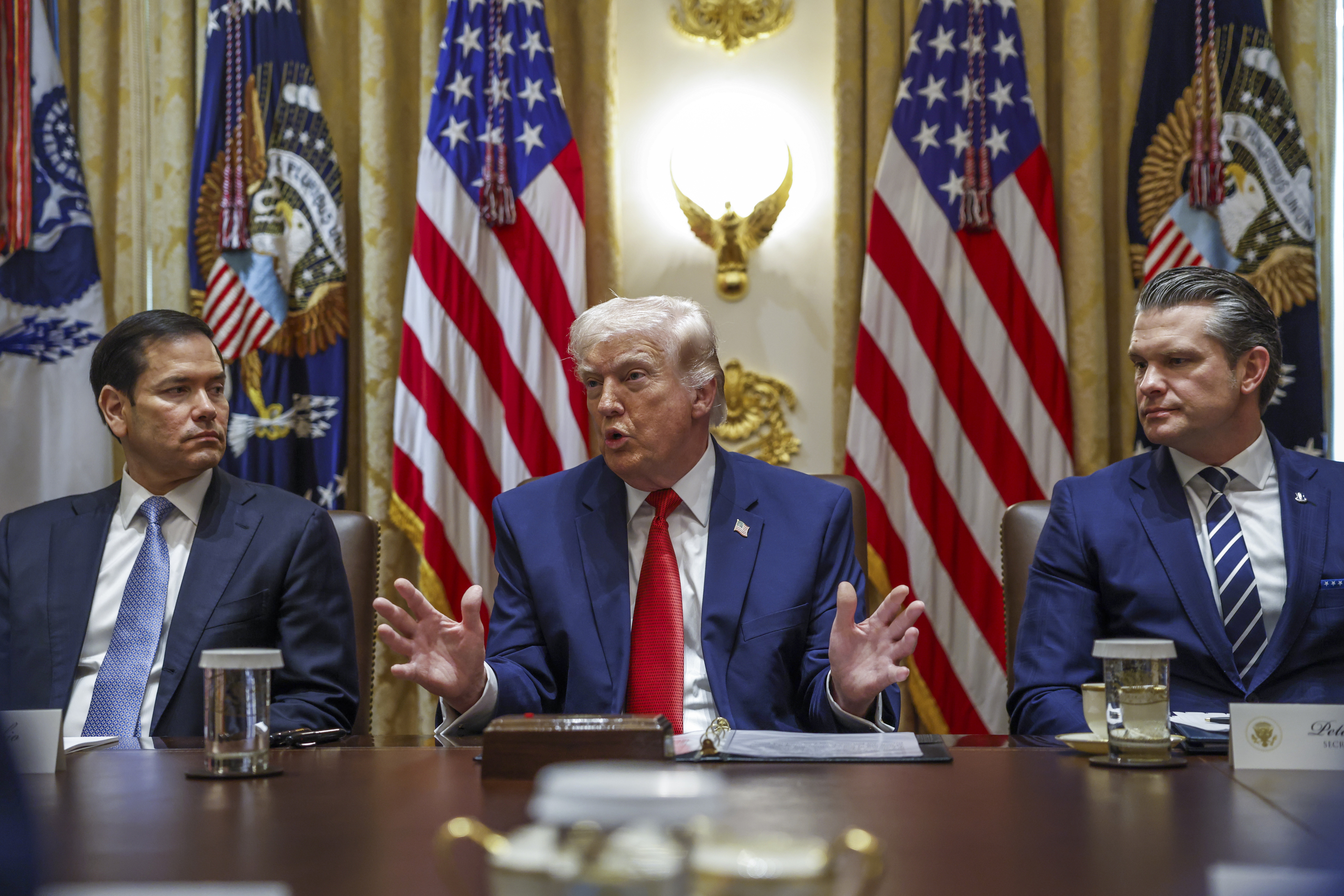 US President Donald J. Trump (C), with Secretary of State Marco Rubio (L) and Secretary of Defense Pete Hegseth (R), responds to a question from the news media during a cabinet meeting in the Cabinet Room of the White House in Washington, DC, USA, 26 March 2026.  EPA/WILL OLIVER / POOL