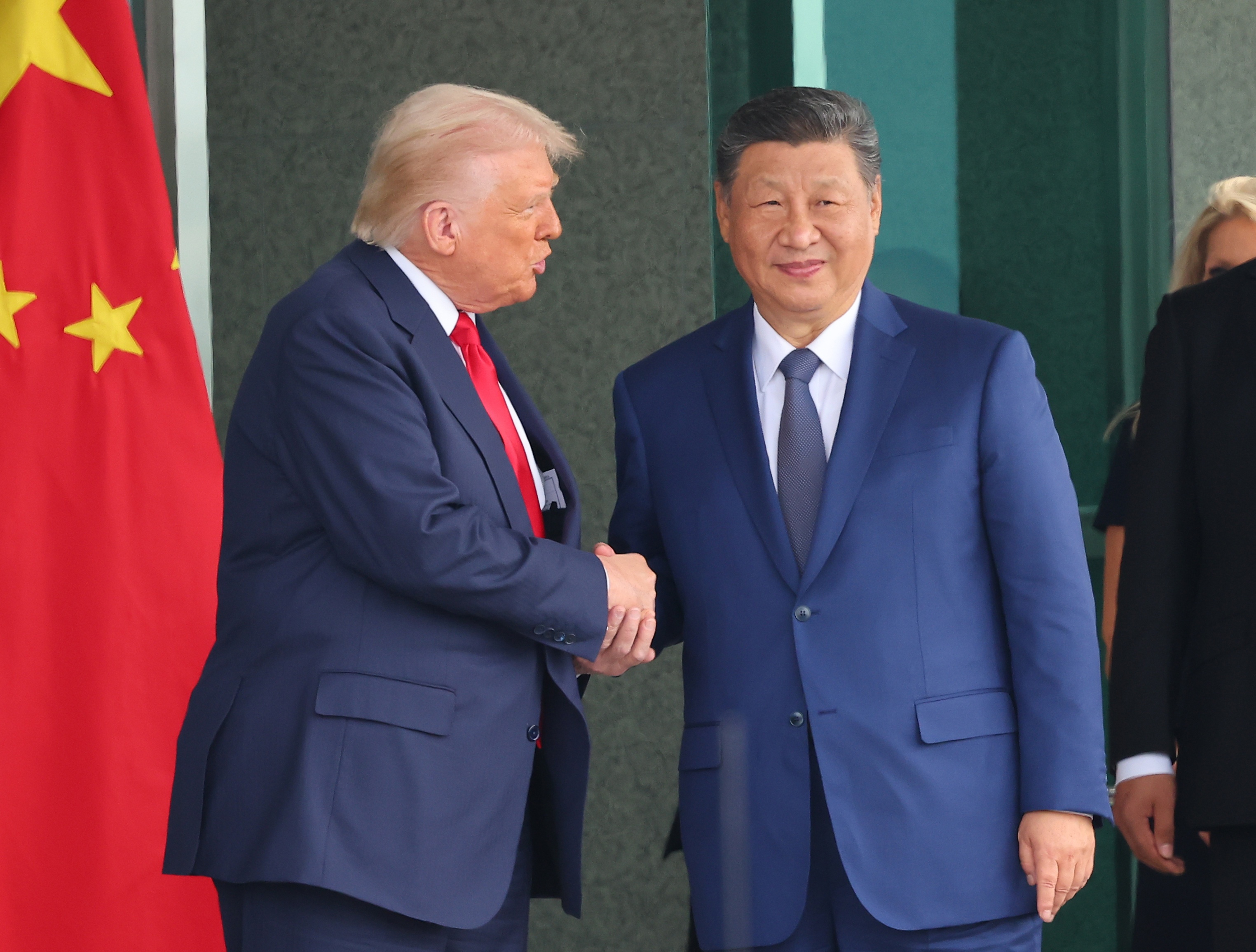 US President Donald Trump (L) and Chinese President Xi Jinping (C) shake hands following their meeting at the Naraemaru reception hall inside an Air Force base in Busan, South Korea, 30 October 2025.  EPA/YONHAP SOUTH KOREA OUT
