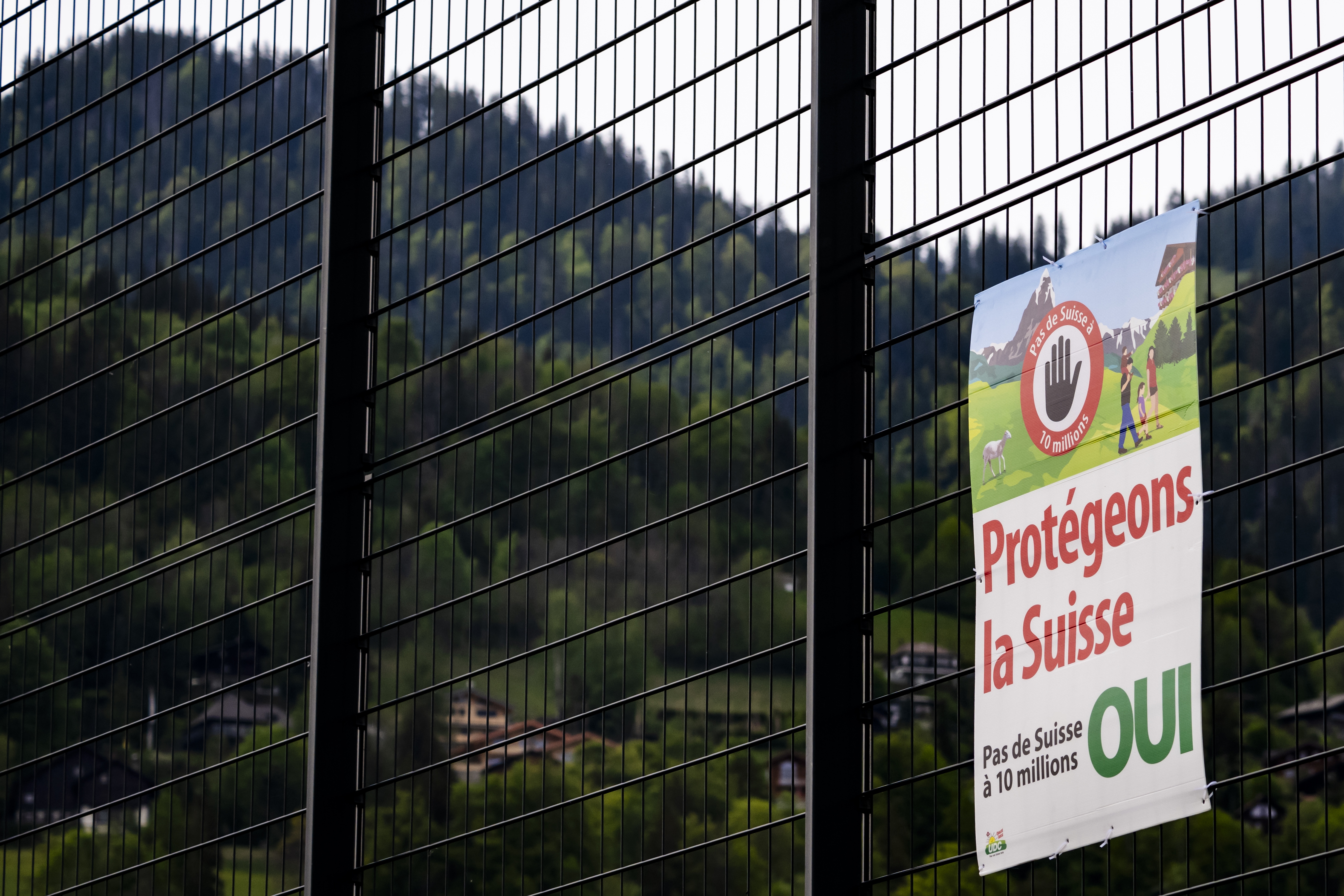 An electoral poster for the right-wing Swiss People's Party (SVP) popular initiative reading 'Let's protect Switzerland. No to Switzerland of 10 million!' is attached to a fence in Charmey, Switzerland, 02 May 2026. SVP's popular initiative 'No to Switzerland of 10 million! (Sustainability Initiative)' aims to cap the permanent resident population at 10 million by 2050. On 14 June 2026, the Swiss people will vote on this popular initiative.  EPA/JEAN-CHRISTOPHE BOTT