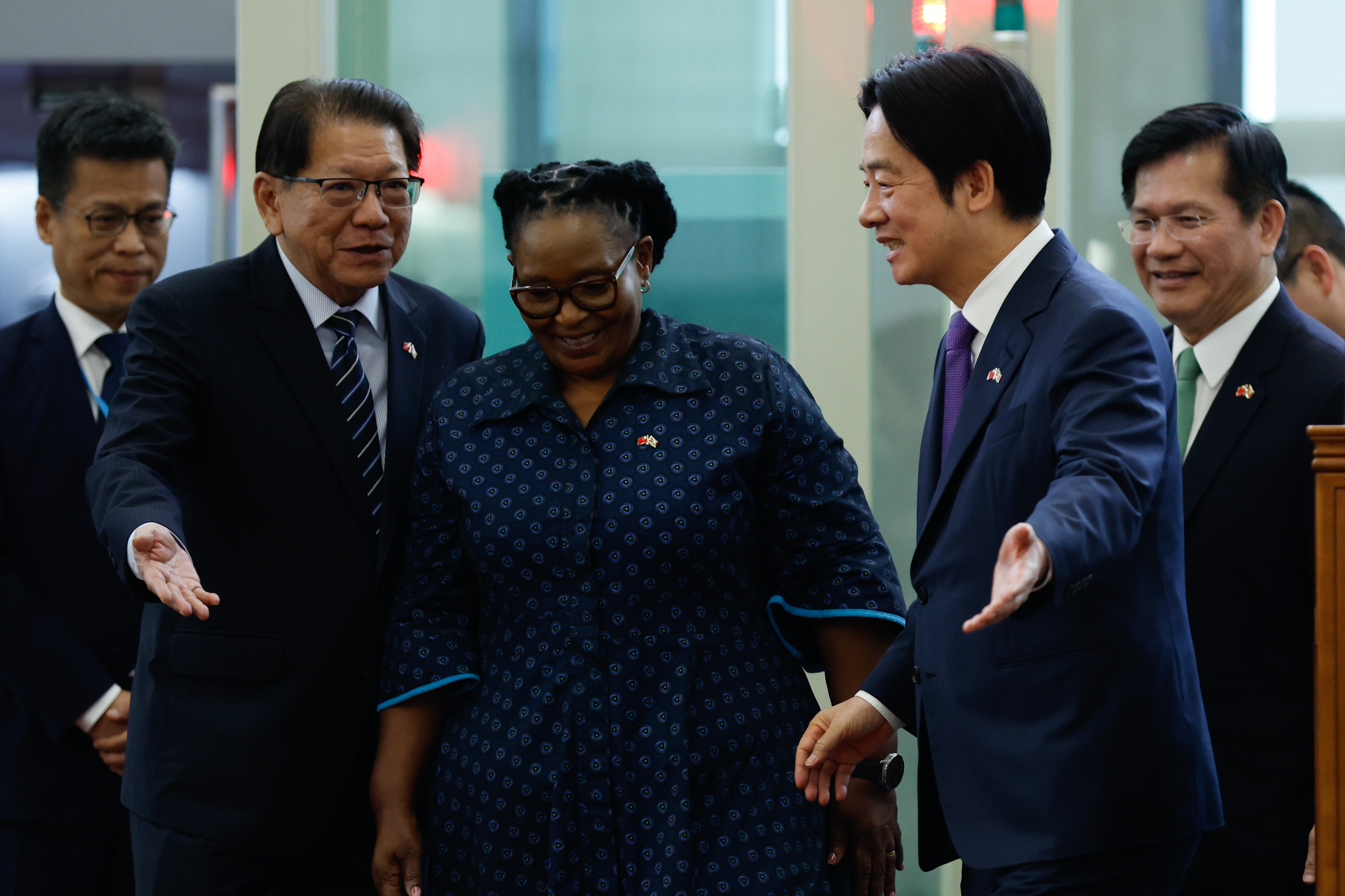 Taiwan President Lai Ching-te (2-R) walks with Eswatini Deputy Prime Minister Thulisile Dladla (C) upon his arrival in Taoyuan International Airport, in Taoyuan, Taiwan, 05 May 2026. Lai delivered a speech upon his return to Taiwan after a surprise trip to Eswatini, after his visit was previously delayed when overflight permits were revoked amid Chinese pressure on African countries to deny his plane access to their airspace.  EPA/RITCHIE B. TONGO