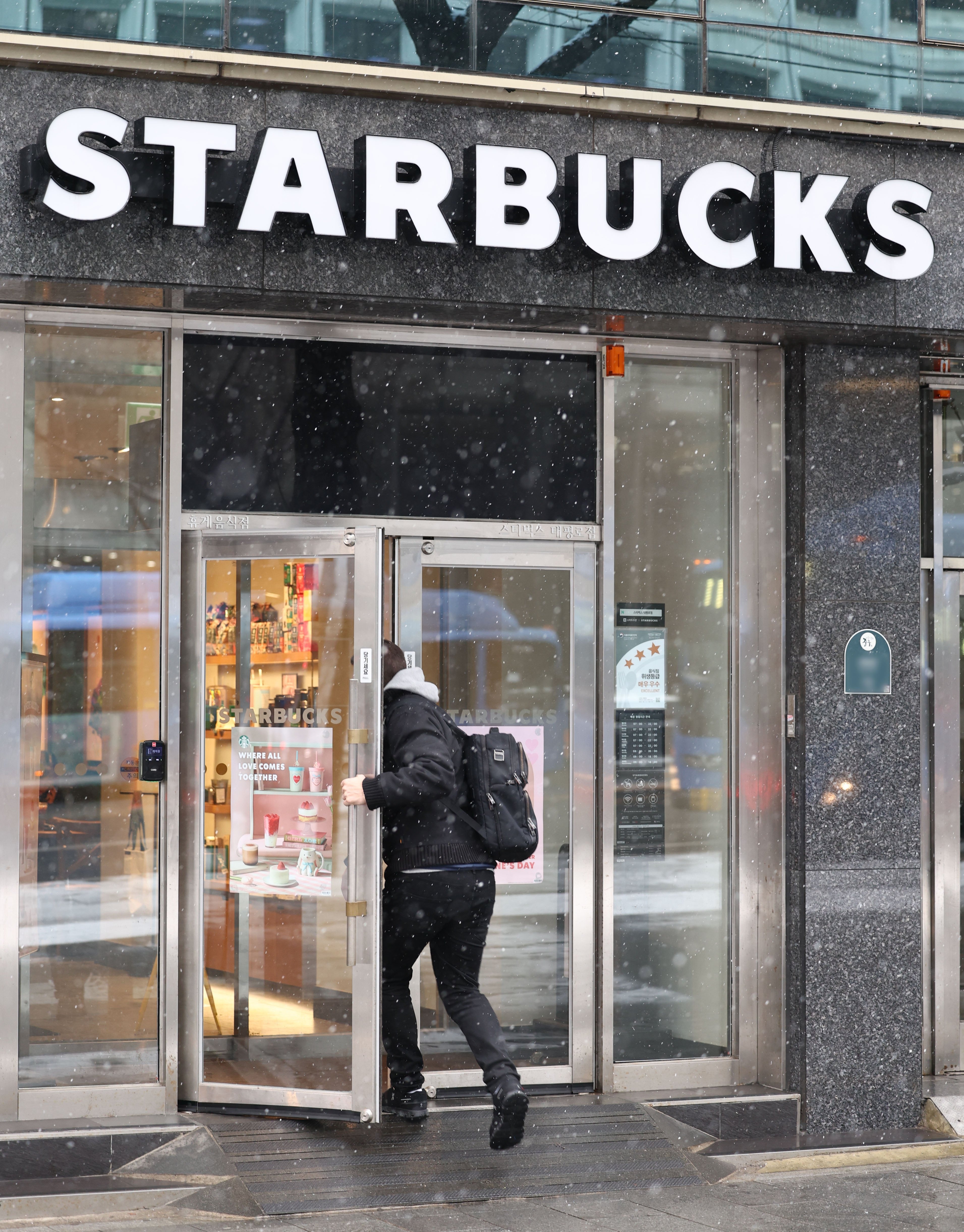 A customer enters a Starbucks coffee chain outlet in Seoul, South Korea, 12 February 2025. Sales of SCK Co., the operator of Starbucks in South Korea, increased 5.8 percent from a year earlier to 3.11 trillion won (around US $2.14 billion) in 2024, with the number of its outlets nationwide rising above 2,000 for the first time since the launch of its first South Korean outlet in 1999. EPA/YONHAP SOUTH KOREA OUT