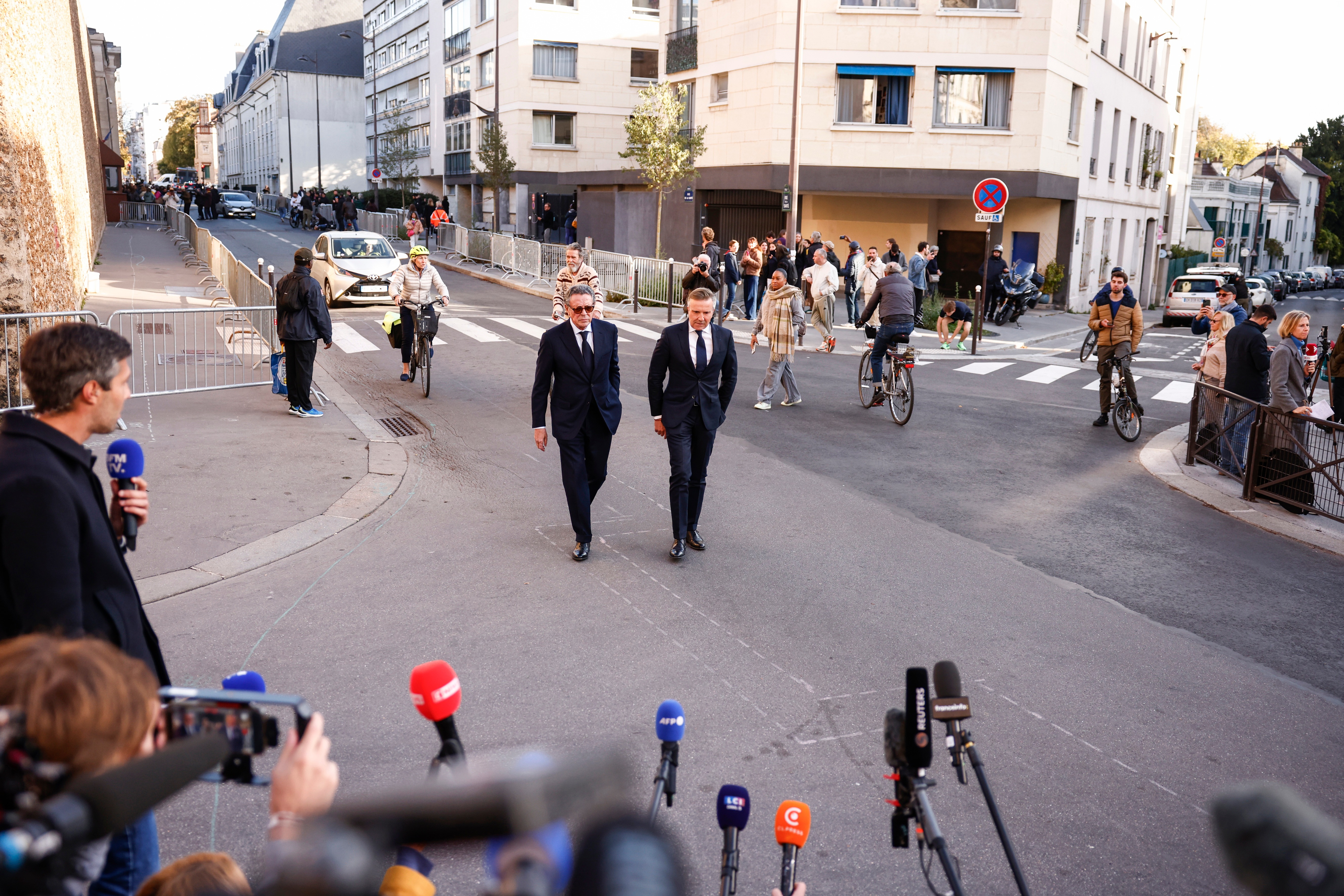 Former French President Nicolas Sarkozy’s lawyers Jean-Michel Darrois (C-L) and Christophe Ingrain (C-R) walk to address the media in front of La Sante Prison in Paris, France, 21 October 2025. Sarkozy is to be jailed on 21 October after he was sentenced to five years in prison for receiving funds for the 2007 presidential campaign from the regime of late Libyan leader Muammar Gaddafi. EPA/YOAN VALAT