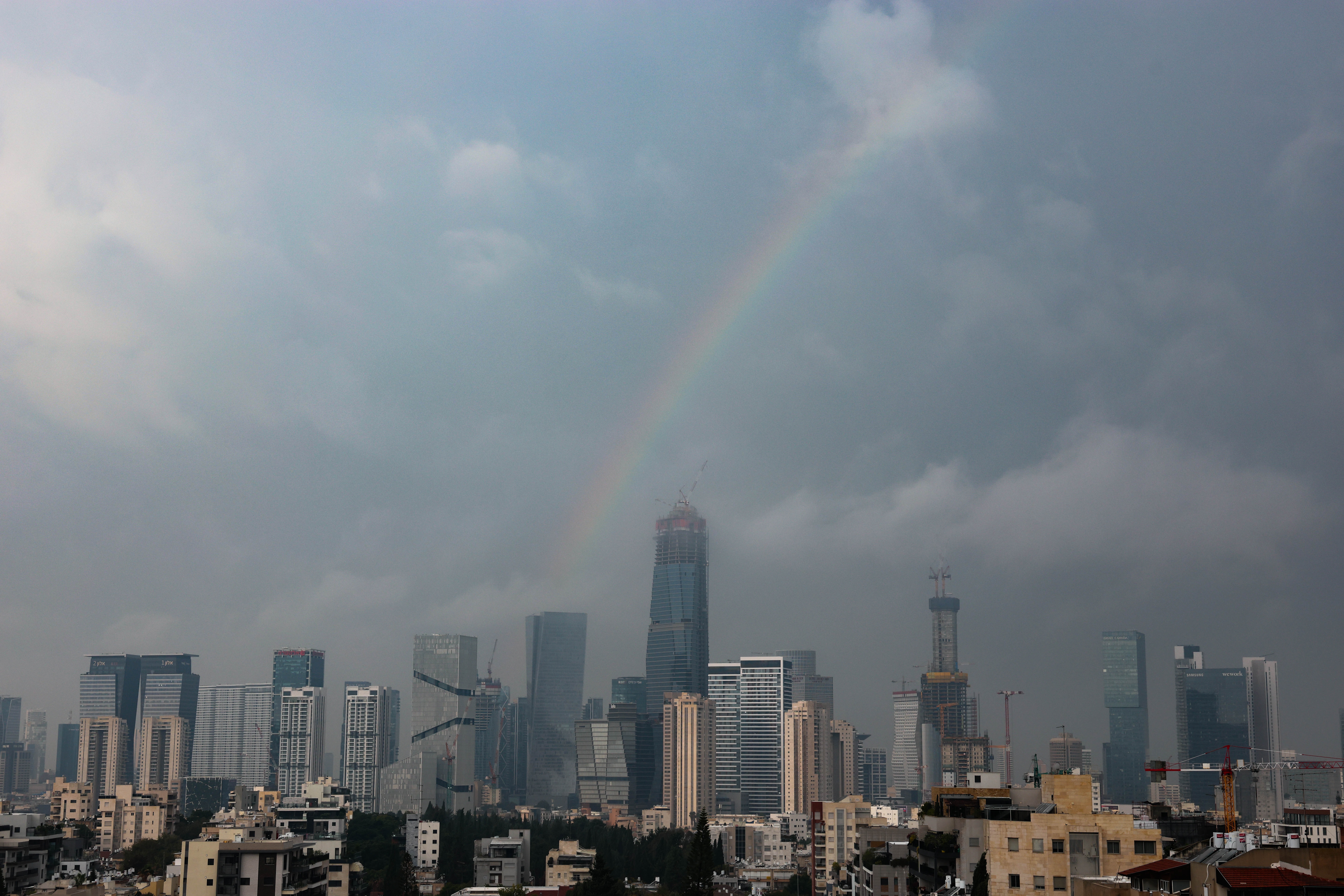 A rainbow is visible over the skyline during stormy weather in Tel Aviv, Israel, 11 December 2025. According to the Israel Meteorological Service (IMS), a three-day storm called 'Byron,' which started on 09 December, is expected to cause exceptional damage across the country. The storm is forecast to intensify on 11 December before gradually decreasing, with flooding expected.  EPA/ABIR SULTAN