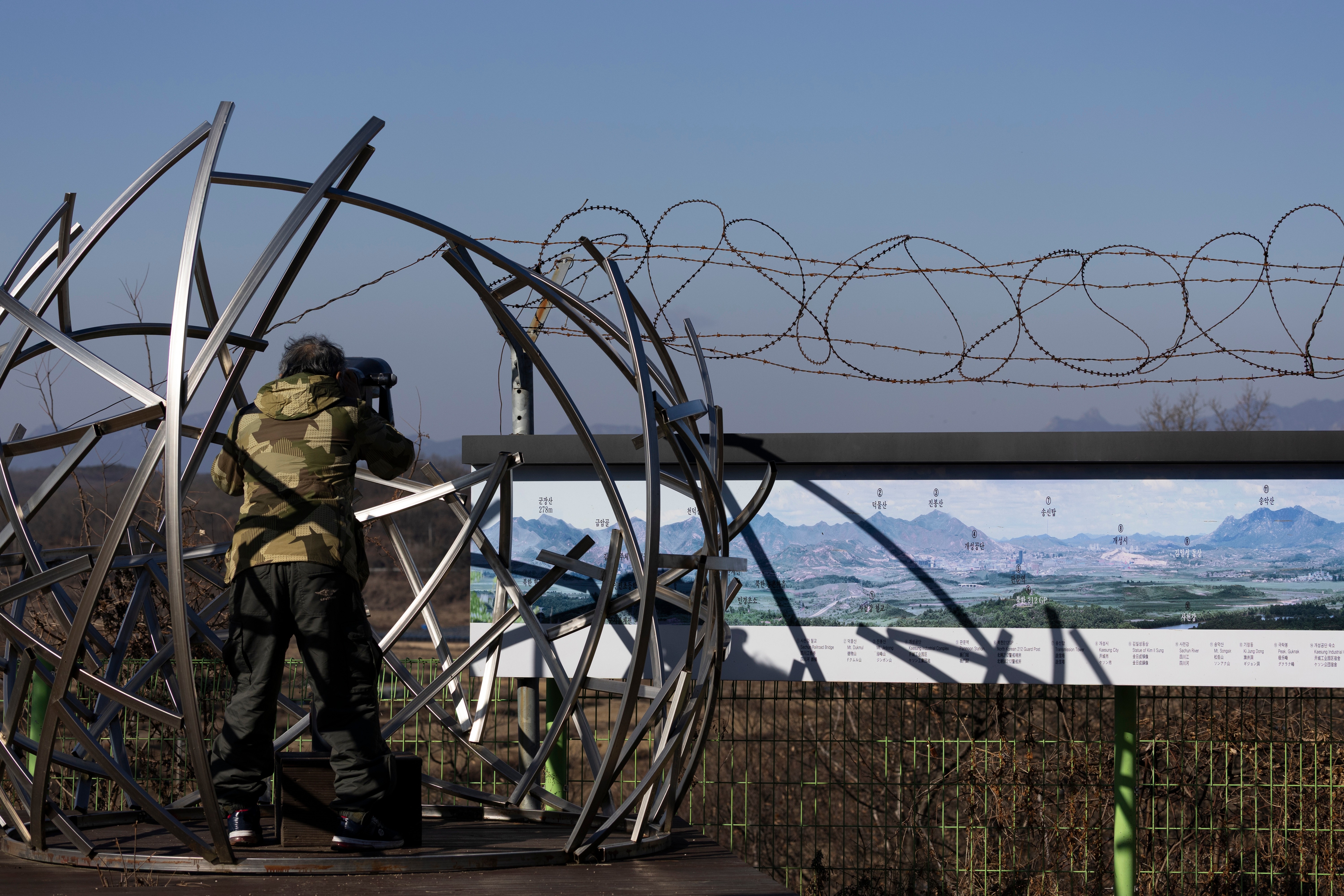 A man looks through binoculars toward the North Korean side of the border from the Tongilchon Village near the Demilitarised Zone (DMZ) in Paju, Gyeonggi-do province, South Korea, 25 December 2025. According to South Korea's Joint Chiefs of Staff (JCS), North Korea launched a test firing of new anti-air missiles toward the East Sea on 24 December. EPA/JEON HEON-KYUN