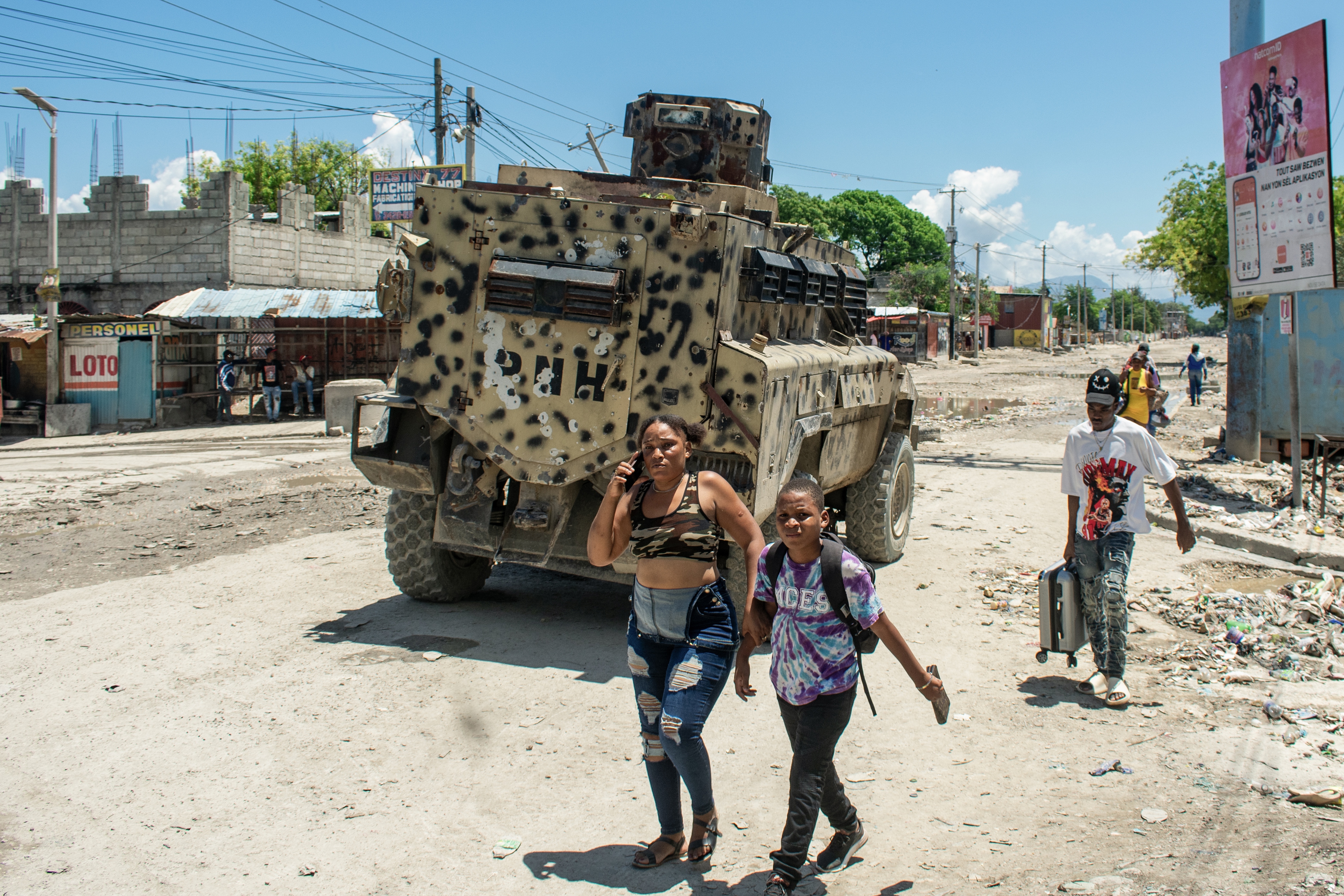 Haiti residents of Cite Soleil leave the area after gang attacks