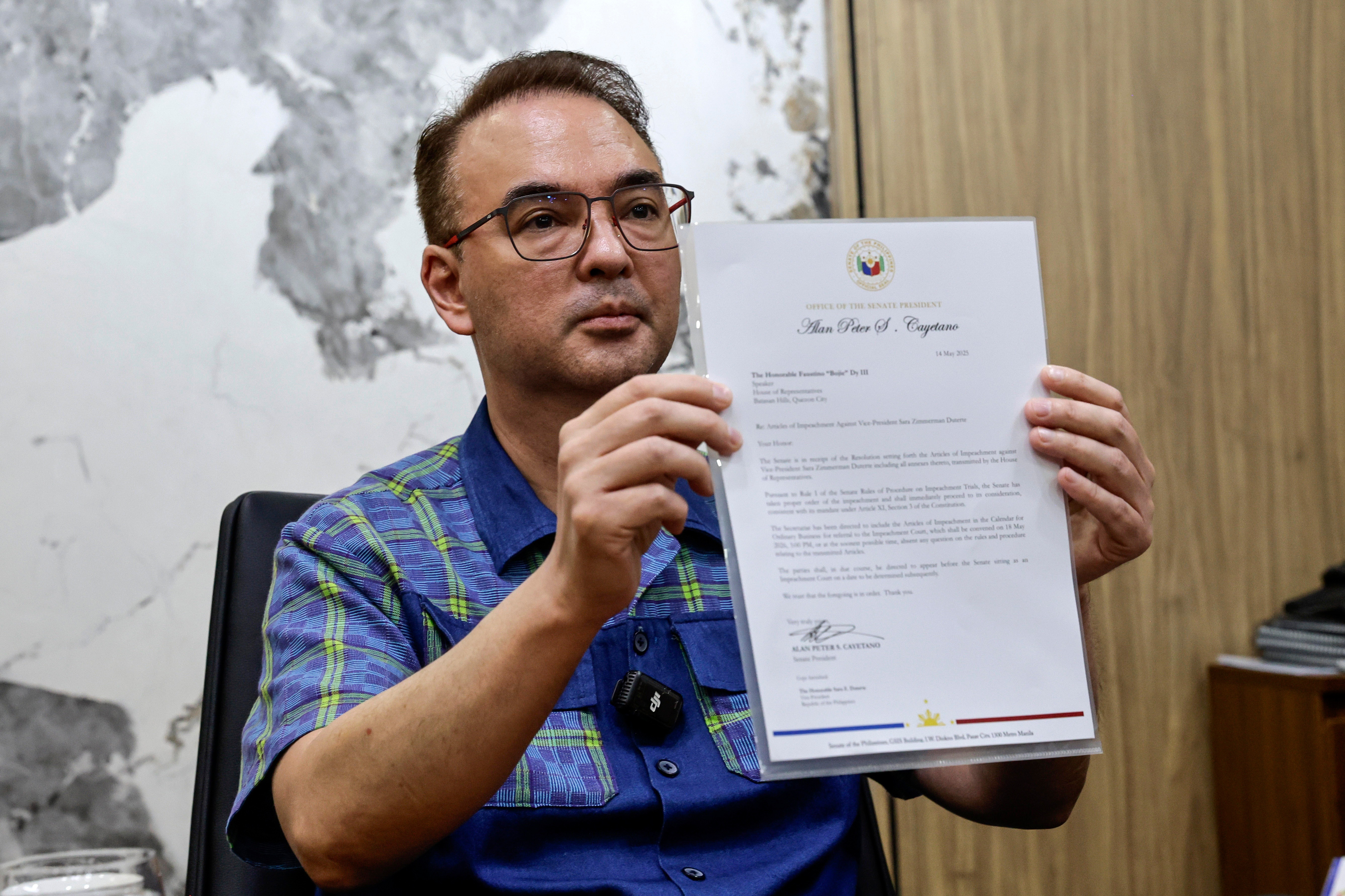 Philippines Senate President Alan Peter Cayetano shows a document verifying the receipt of related documents from the House of Representatives (HOR) pertaining to articles of impeachment against Vice-President Sara Duterte, at the Senate in Pasay City, Metro Manila, Philippines, 14 May 2026. The Senate is expected to convene as a trial court, after Duterte was impeached by the HOR on 11 May. EPA/ROLEX DELA PENA