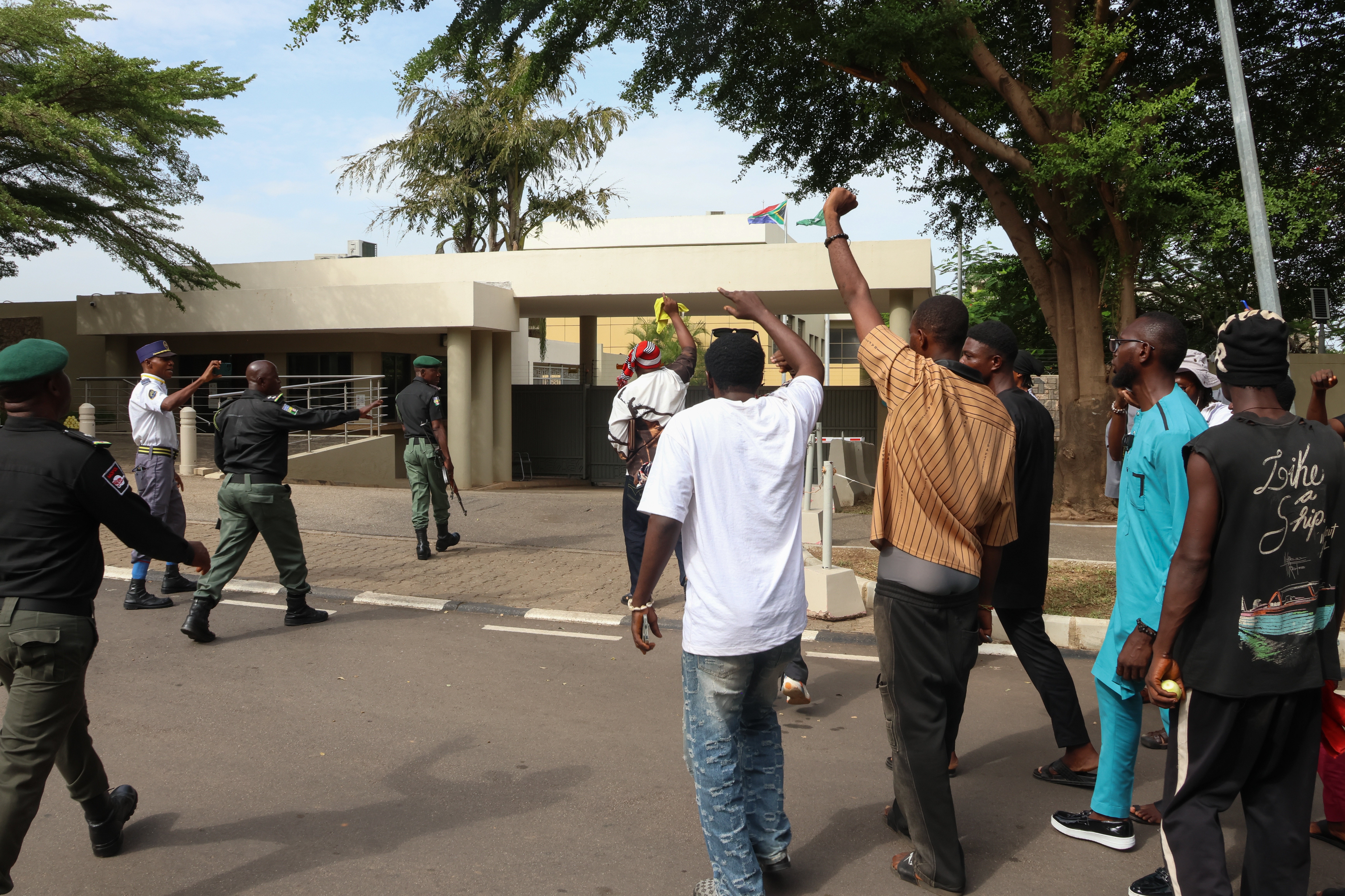 Police officers screen activists outside the South African High Commission during a rally in Abuja, Nigeria, 18 May 2026. Activists protest xenophobic violence targeting Nigerians accused of being undocumented immigrants in South Africa. EPA/AFOLABI SOTUNDE