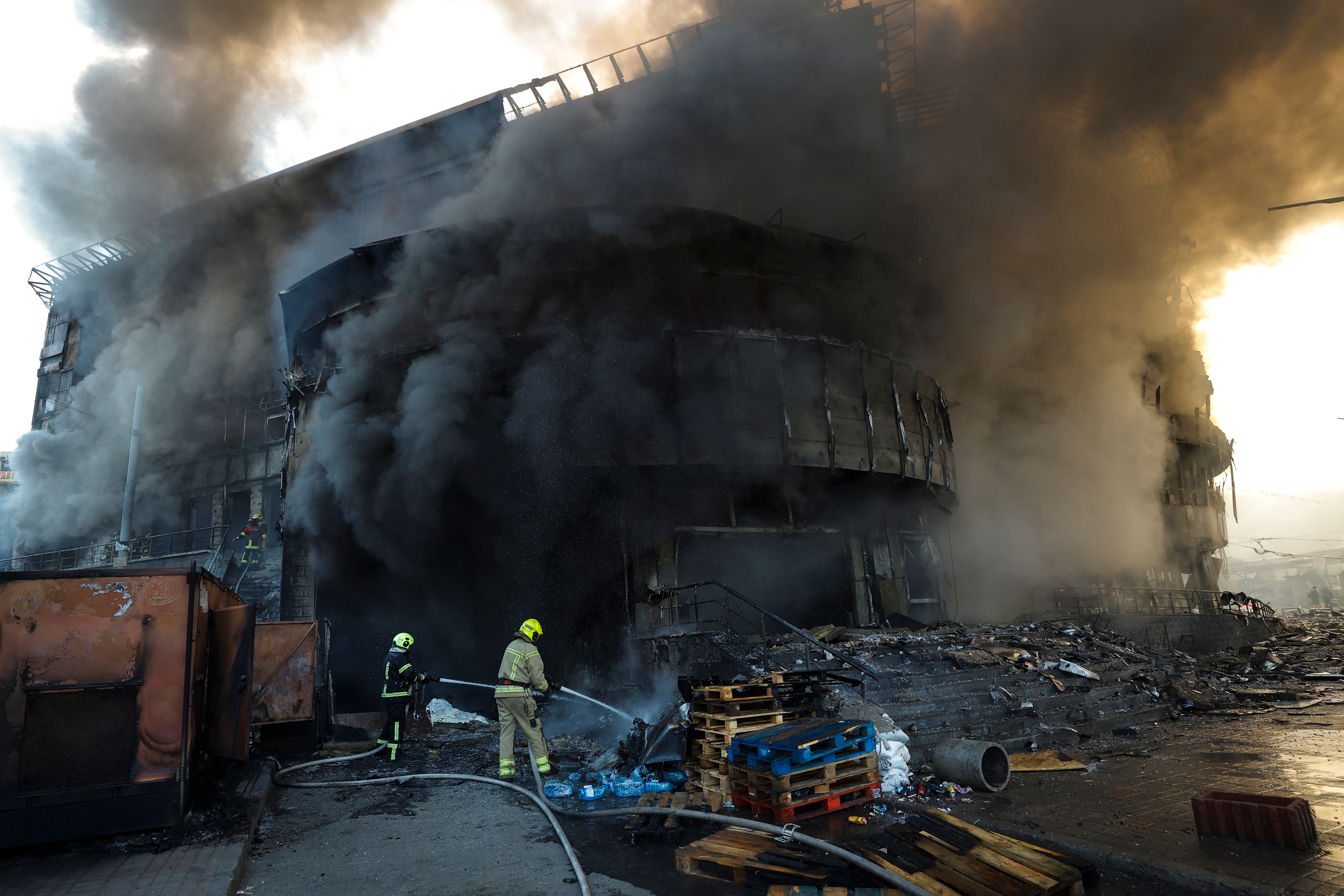 Smoke rises as Ukrainian rescuers work at the site of a Russian strike on a shopping center in Kyiv, Ukraine, 24 May 2026, amid the Russian invasion. More than 600 drones and 90 missiles struck several sites across Kyiv overnight on 24 May, resulting in at least two confirmed fatalities and more than 80 injuries, according to Ukrainian President Volodymyr Zelensky. EPA/SERGEY DOLZHENKO