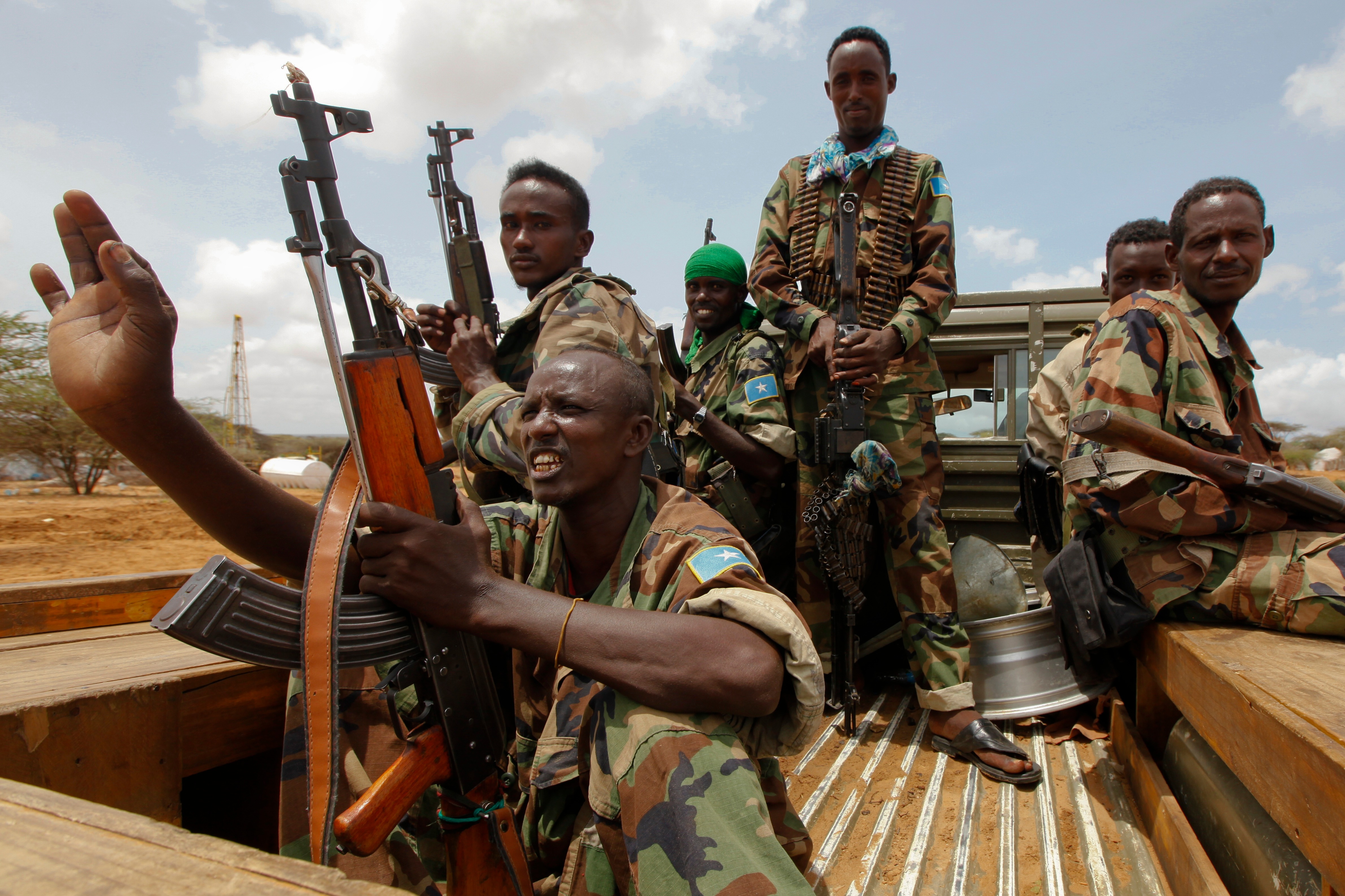 Somali government soldiers are seen aboard a pickup truck at a military base in Afgoye district, some 30km northwest of the capital Mogadishu, Somalia, 08 August 2012. Backed by 12,000-strong African Union forces, Somalia's western-backed government has in recent months taken control of a series of key strongholds, including the capital Mogadishu from the hardline Islamist militants al-Shabab. However, international observers say al-Shabab remains major threat to the stability of the country ahead of the political transition to be completed by 20 August 2012. EPA/DAI KUROKAWA