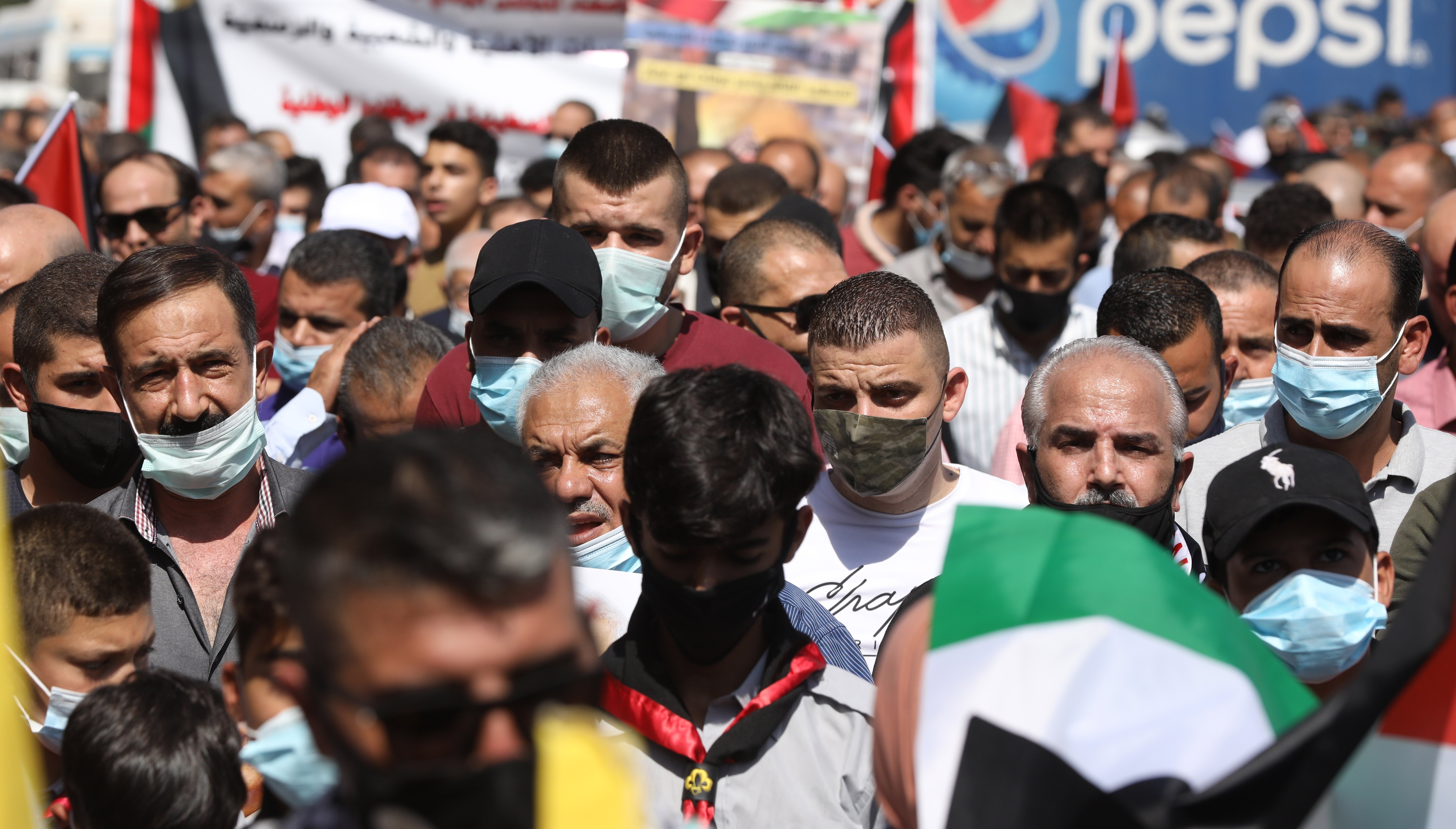  Palestinians wave their national flags during a protest against the peace agreement to establish diplomatic ties between Israel, Bahrain and the United Arab Emirates, in the West Bank city Tubas, 27 September 2020. EPA/ALAA BADARNEH