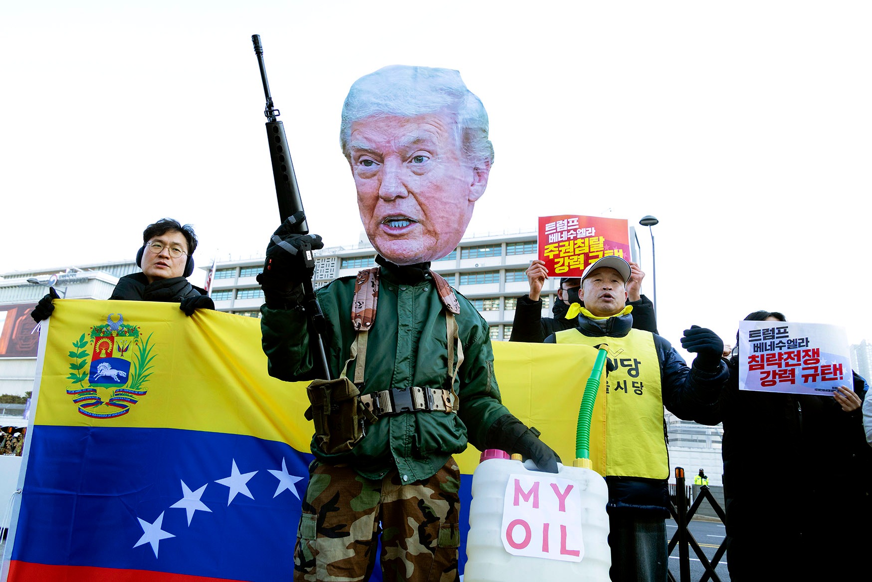 A protester wearing a mask featuring the likeness of US President Donald Trump at a protest outside the US Embassy in Seoul, South Korea, on 5 January, against Trump and the US military actions in Venezuela.  (Photo: Jeon Heon-Kyun / EPA)