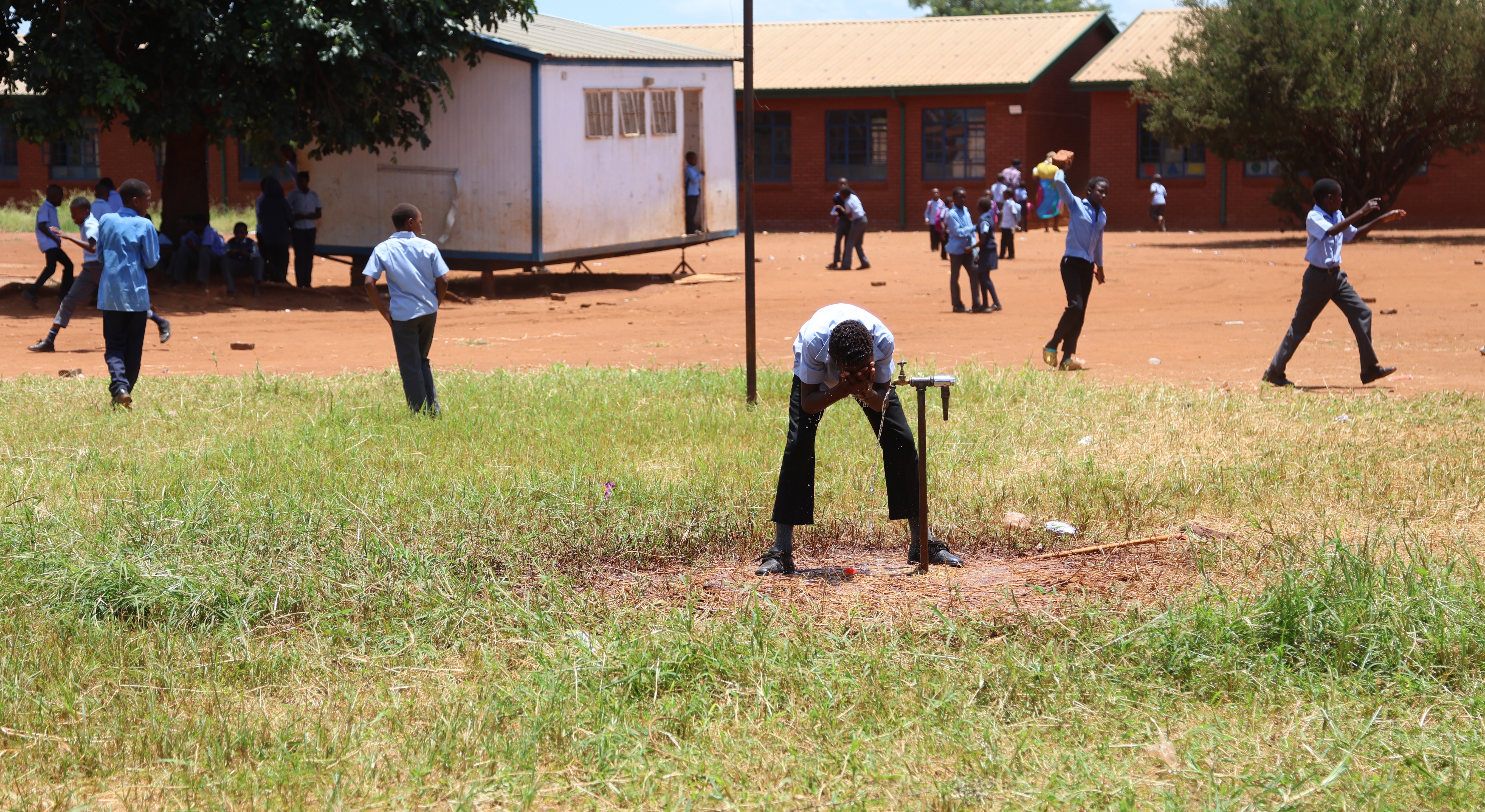 With temperatures soaring after recent rains, a learner cools off during break at Rhida Primary School in Mapayeni. (Photo: Felix Dlangamandla)