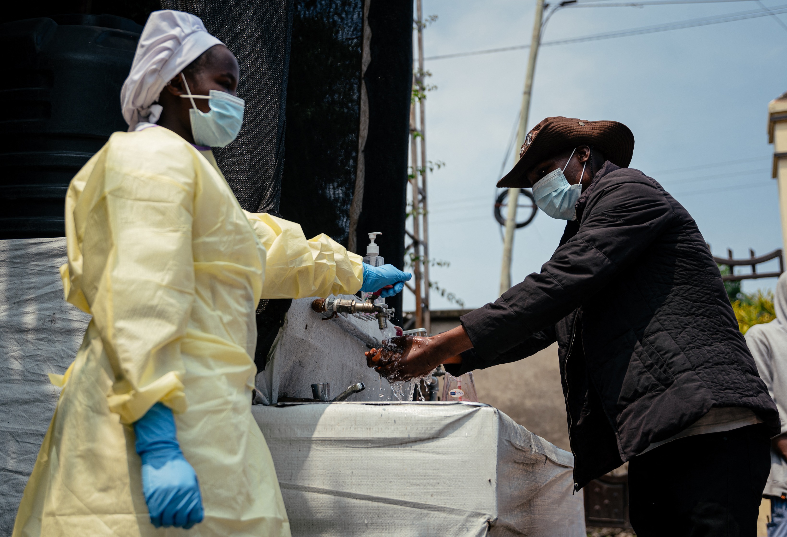 A visitor washes his hands at a checkpoint before entering Kyeshero Hospital in Goma, DRC, on 18 May as part of Ebola prevention measures. (Photo: Jospin Mwisha / AFP)