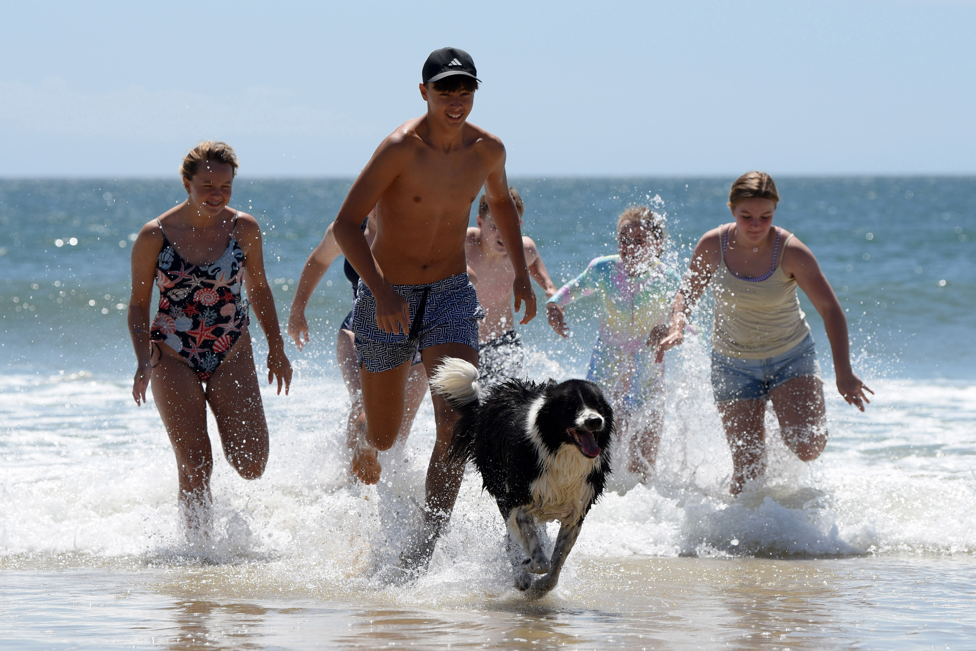 Cayden Kingsley chases Oreo out of the surf of Kings Beach in Gqeberha  (Photo: Deon Ferreria)