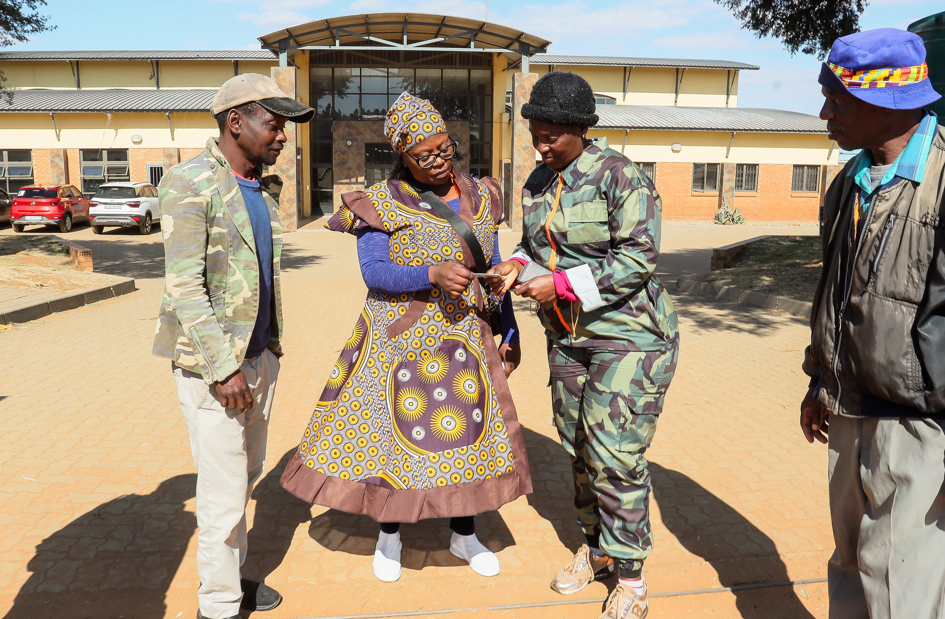 Operation Dudula members outside a clinic in Braamfischer, Soweto, check the passports and IDs of those entering the clinic. (Photo: Fani Mahuntsi / Gallo Images)