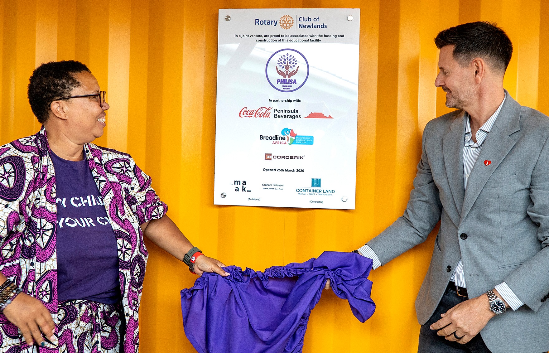 Lucinda Evans, founder of the Cape Town non-profit organisation Philisa Abafazi Bethu, and Charl Goncalves, managing director of Coca Cola Peninsula Beverages, unveil the plaque at the opening of the Philisa Young Minds Academy in Retreat, Cape Town, on Wednesday 25 March 2026. (Photo: Supplied / Coca Cola Peninsula Beverages)