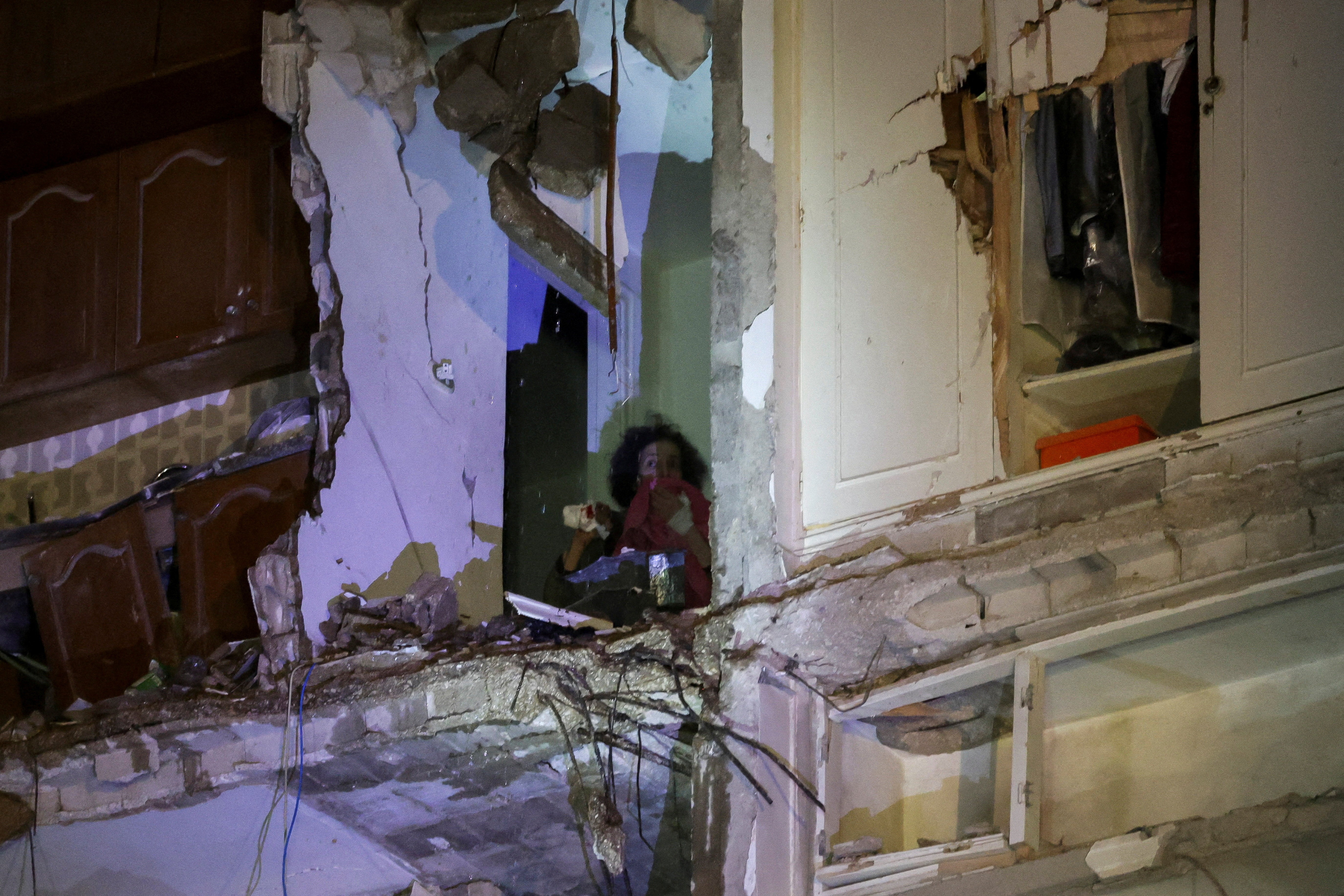 A woman trapped in a building waits to be rescued at the site of an Israeli strike in Beirut, Lebanon, on Wednesday, 8 April. (Photo:  Emilie Madi / Reuters) 