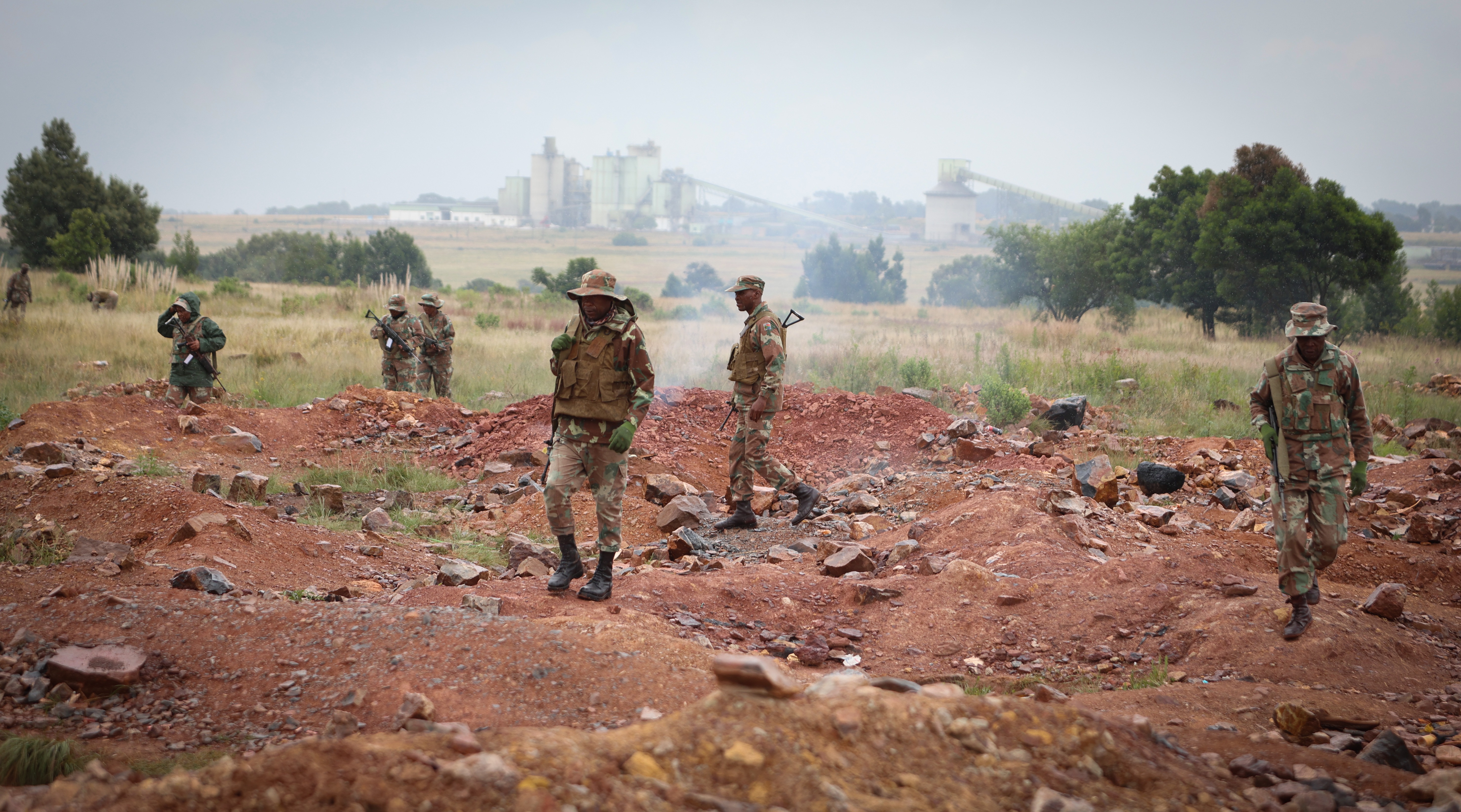 Soldiers patrol an area where illegal mining takes place during a crime prevention operation in Randfontein on 12 March. (Photo: Felix Dlangamandla)