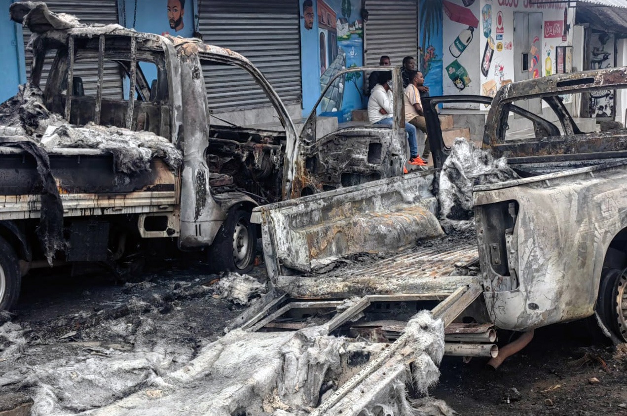 Foreign nationals stand next to their damaged vehicles after violent protests in KuGompo over the alleged coronation of a Nigerian ‘Igbo king’. (Photo: Johnnie Isaac)