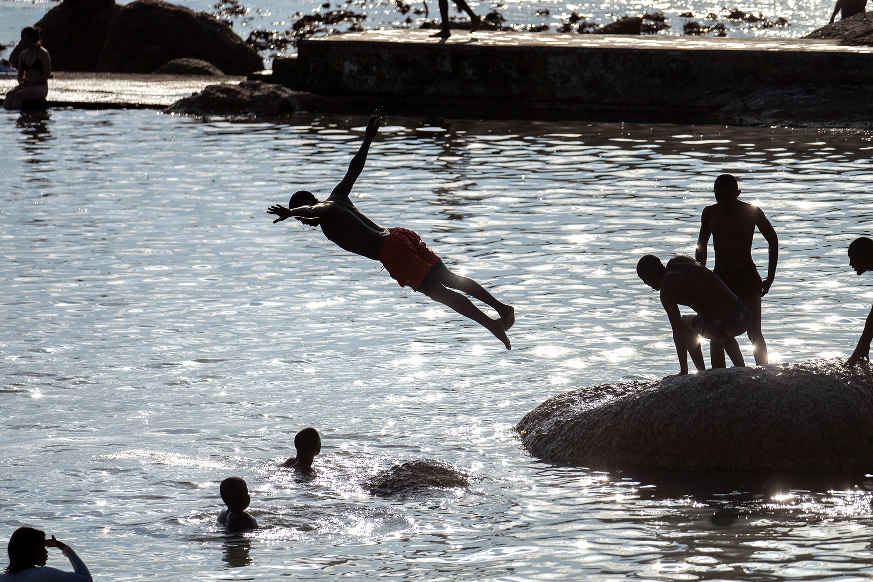 Seeking relief from stifling heat, a man dives into the Camps Bay tidal pool on Wednesday afternoon as Cape Town suffered through its third day of excessive heat.  (Photo: David Harrison)