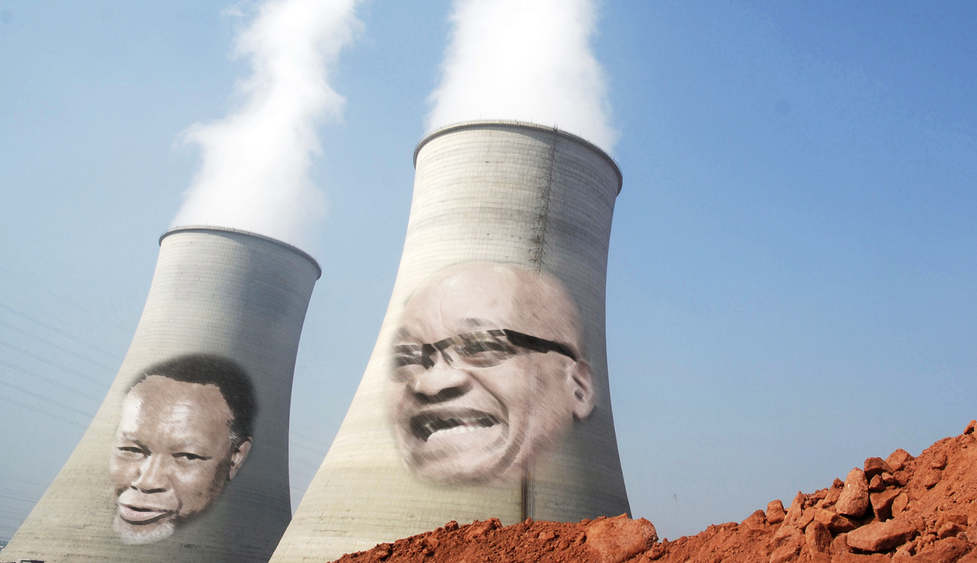 A man walks past the cooling towers of a power plant in Yingtan, Jiangxi province