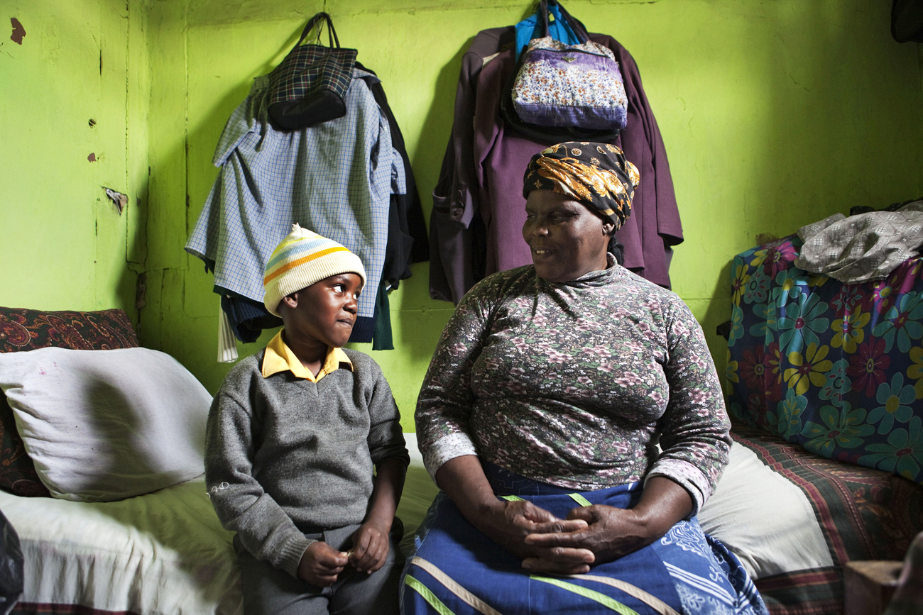 Thenjiwe Madzinga sits with her grandson Thina Gxotelwa in Cape Town's Khayelitsha township