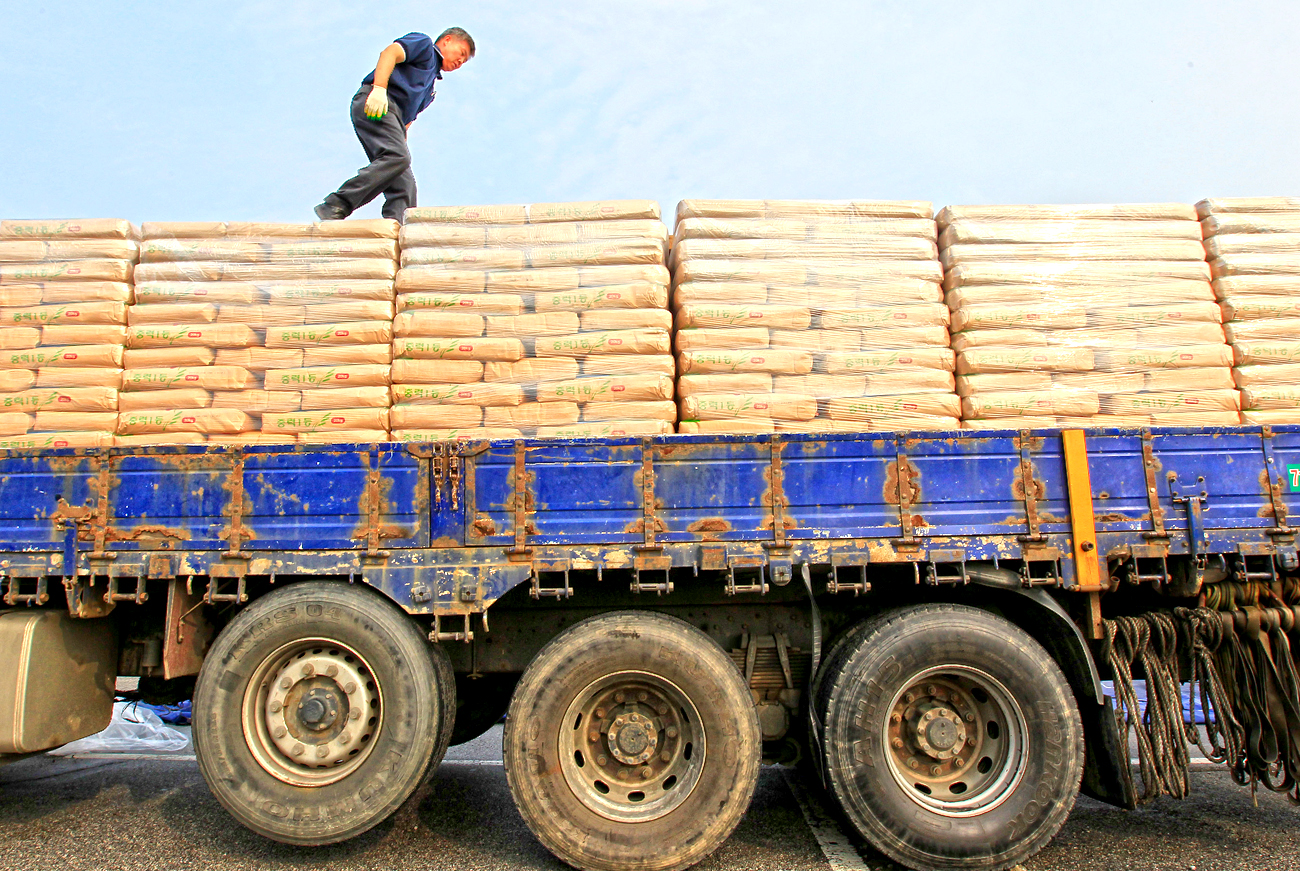 A truck driver walks on a truck carrying sacks of flour to North Korea at a parking lot of Imjingak pavilion near the demilitarized zone separating the two Koreas in Paju