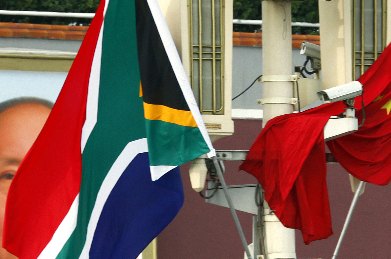 The South African national flag flies beside the Chinese national flag in front of the giant portrait of Chairman Mao in Beijing's Tiananmen Square