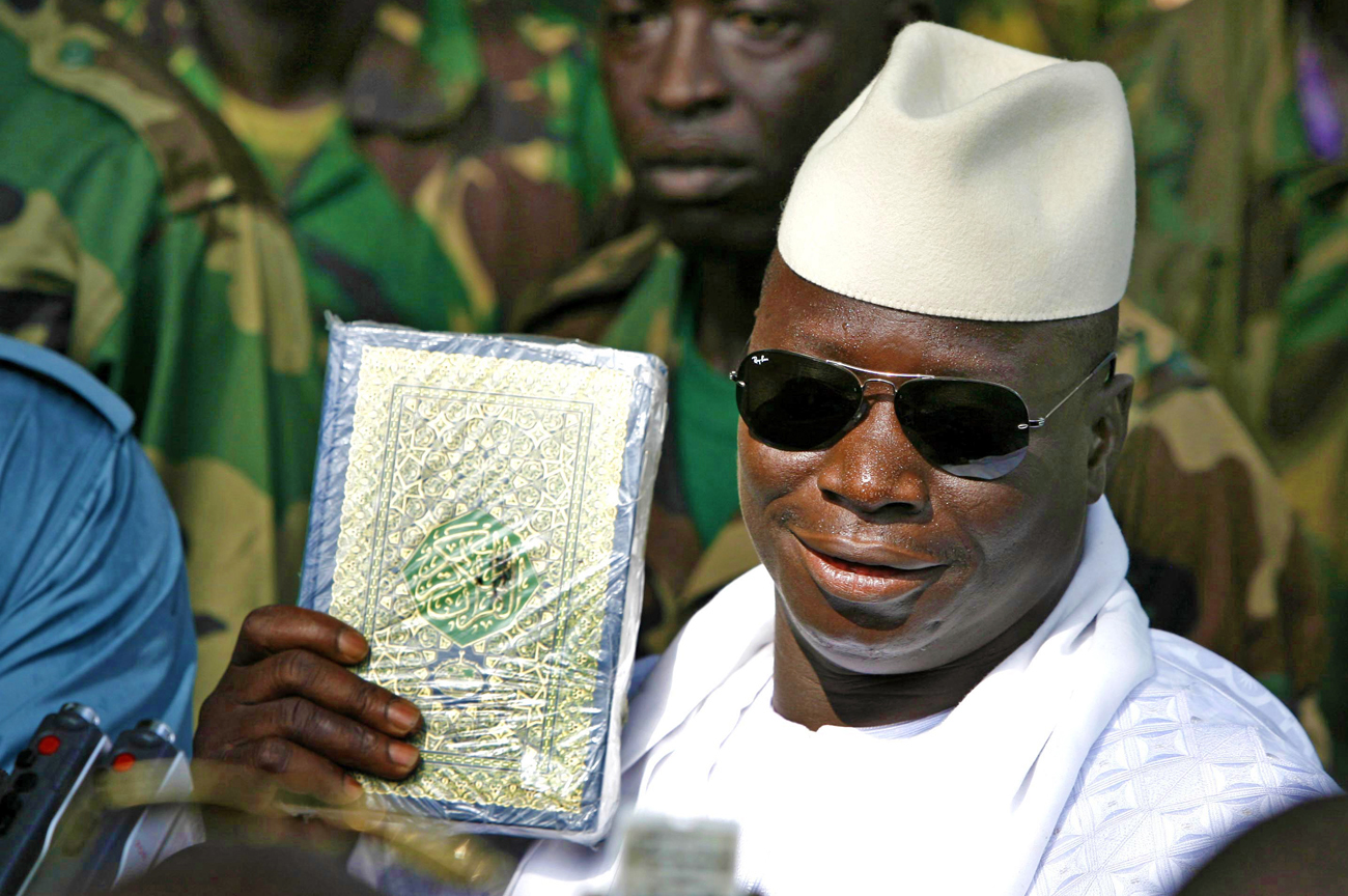 Gambian President Yahya Jammeh holds up a Koran while speaking to the media in Banjul