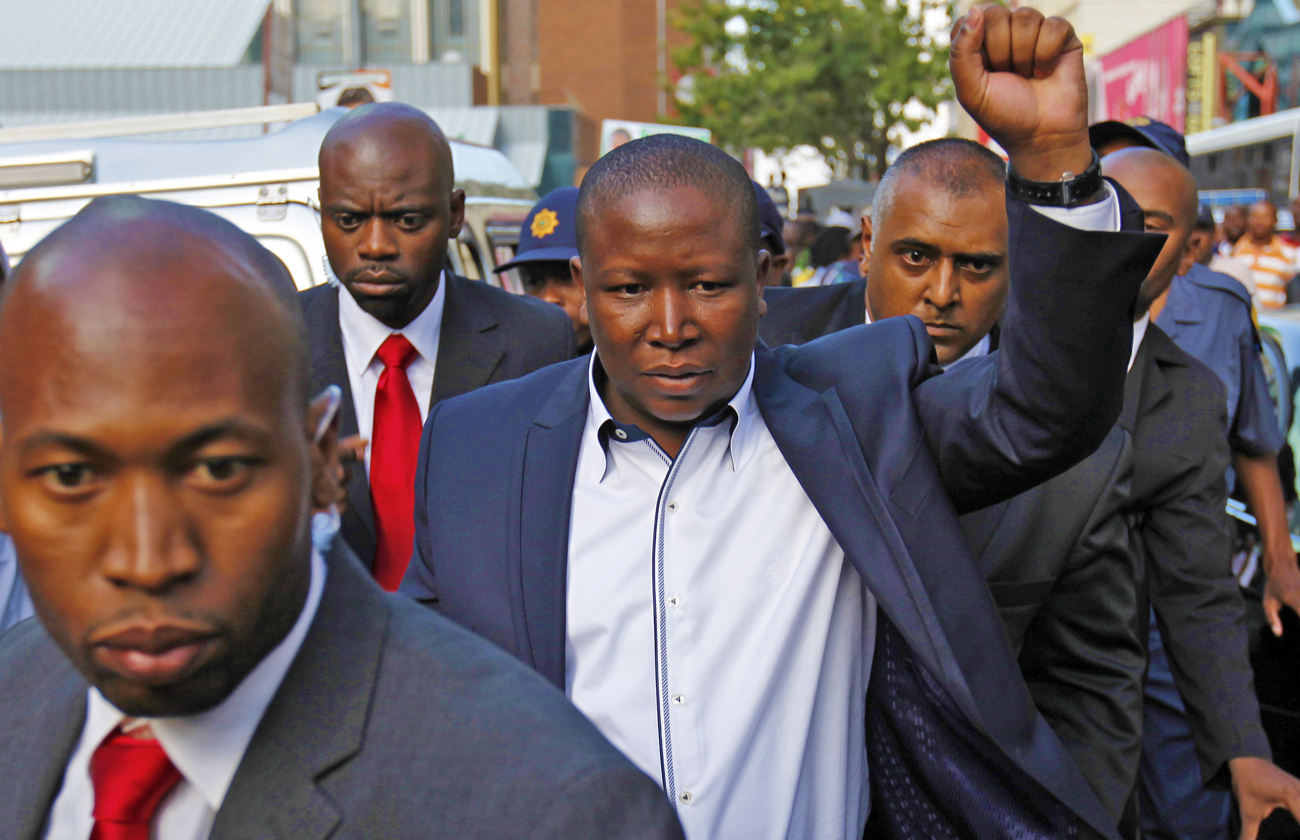 African National Congress Youth League president Malema gestures outside a Johannesburg court, after appearing for a hate speech trial
