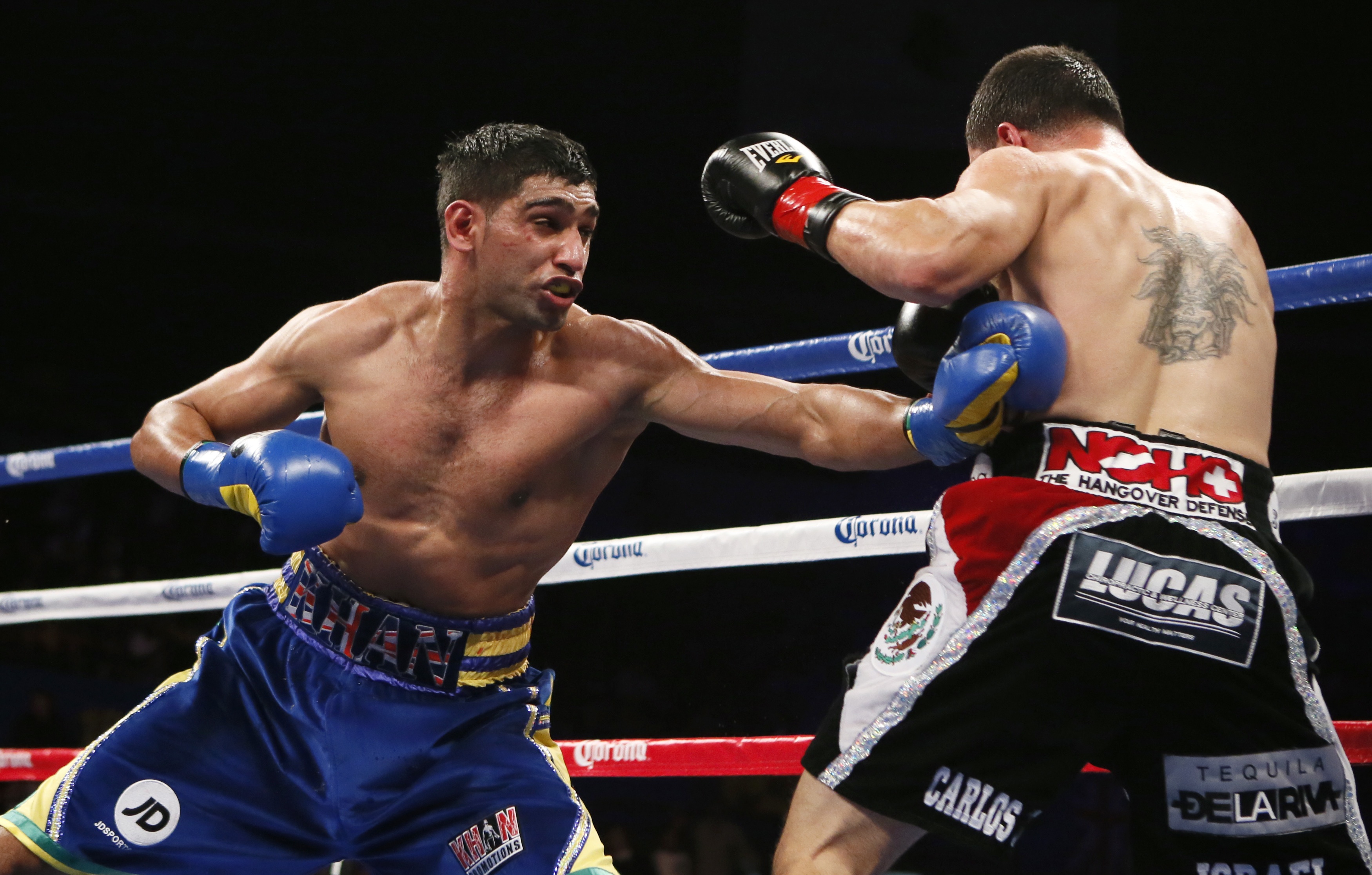 Khan of Britain lands punch on Molina of U.S. during their WBC Silver Super Lightweight title bout in Los Angeles