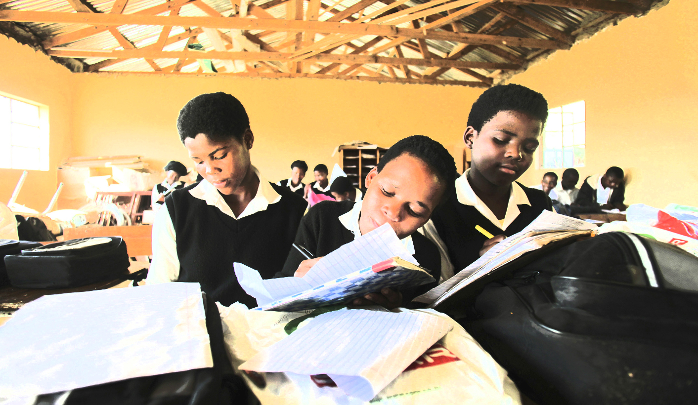 Children write notes from a makeshift black board at a school in Mwezeni village in South Africa's Eastern Cape Province