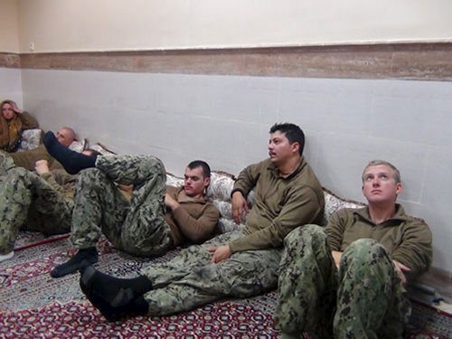 An undated picture released by Iran's Revolutionary Guards website shows American sailors sit in an unknown place in Iran