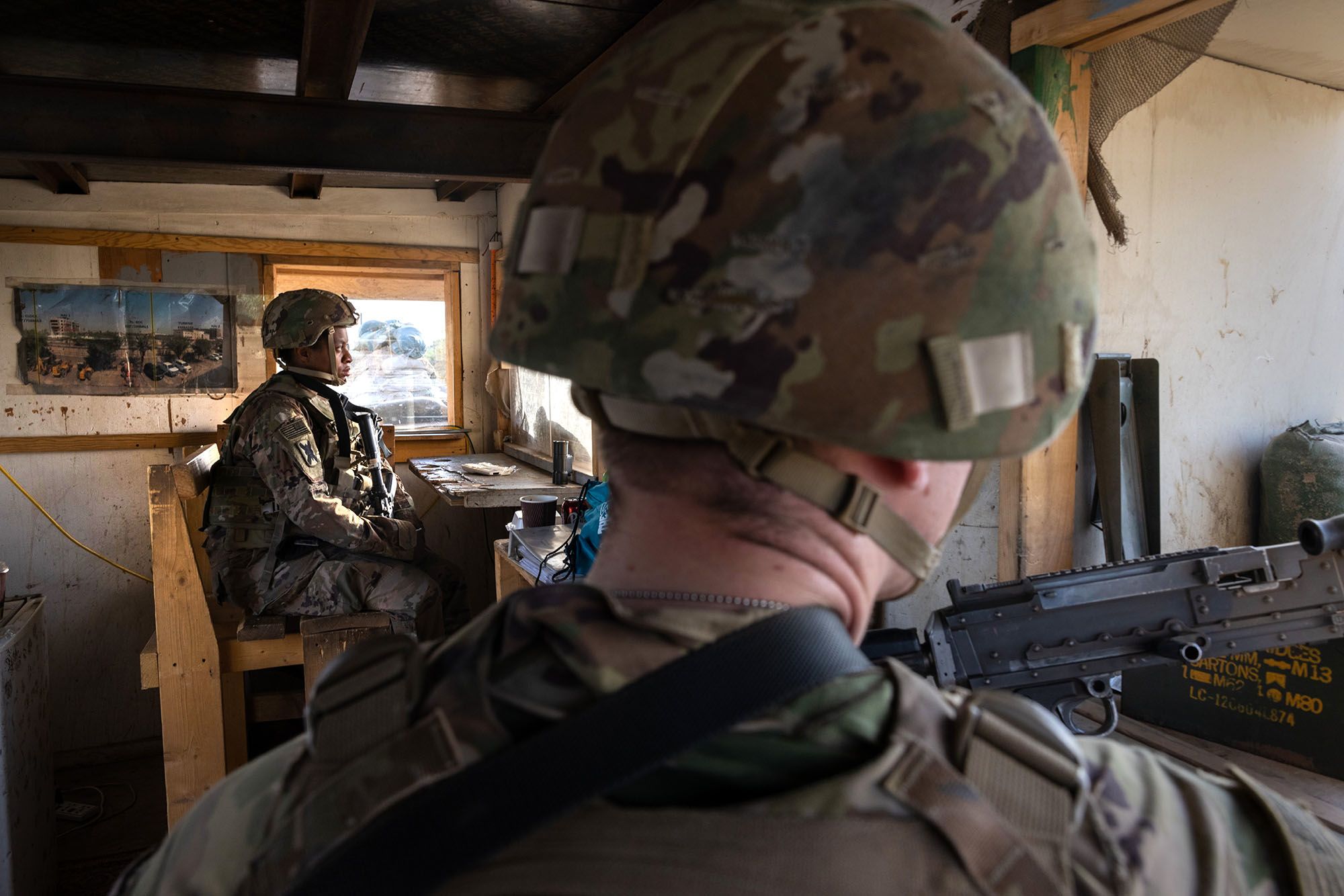 U.S. Army soldiers look onto Baghdad from a guardhouse on the perimeter of the International Zone on May 30, 2021 in Baghdad.